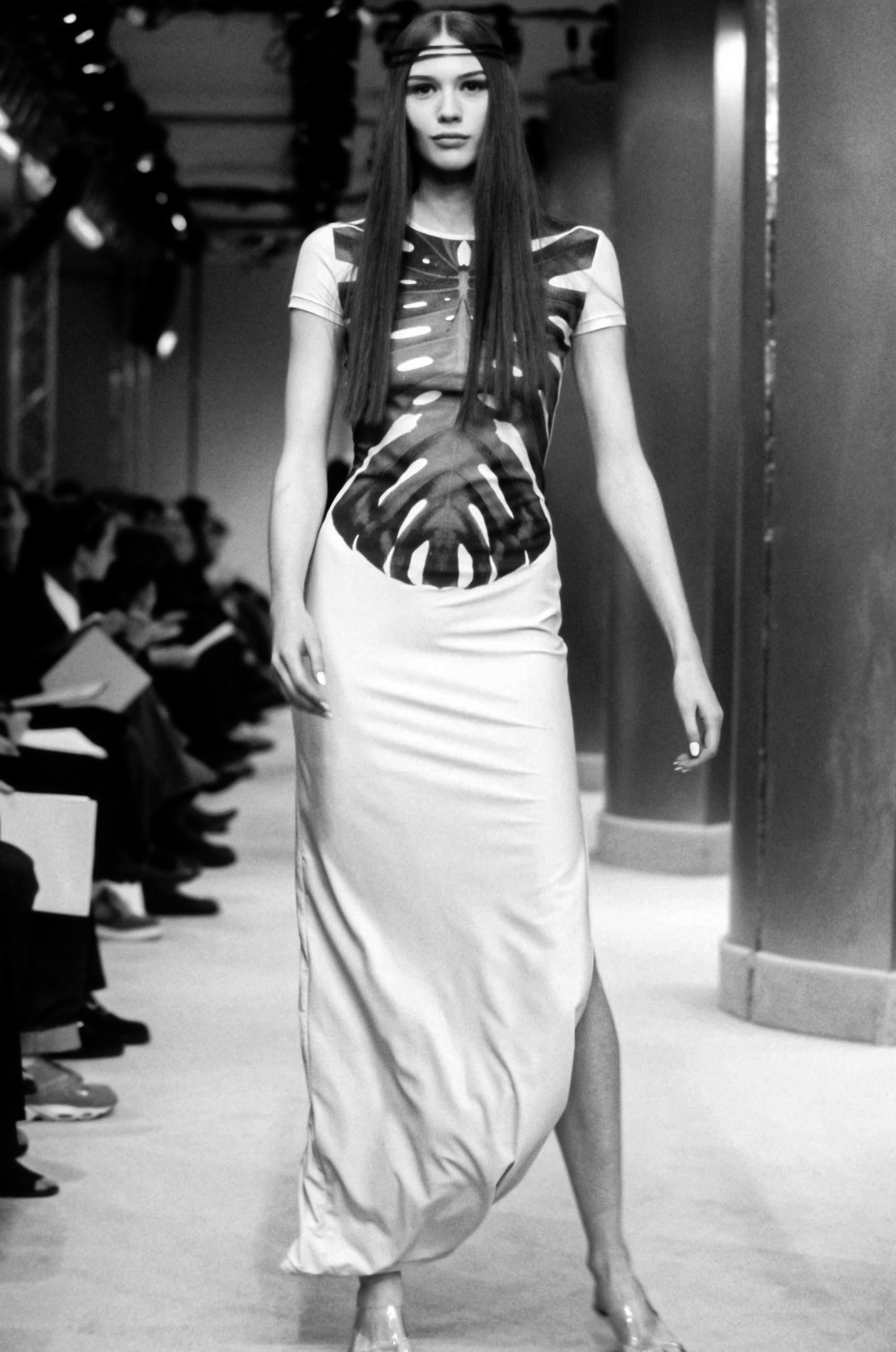 This bold Mugler dress from his 2000 Spring Summer Collection is a striking blend of Couture innovation and artistic expression. The vibrant colour demands attention, while the skeletal-inspired leafprint across the bodice adds an unexpected touch