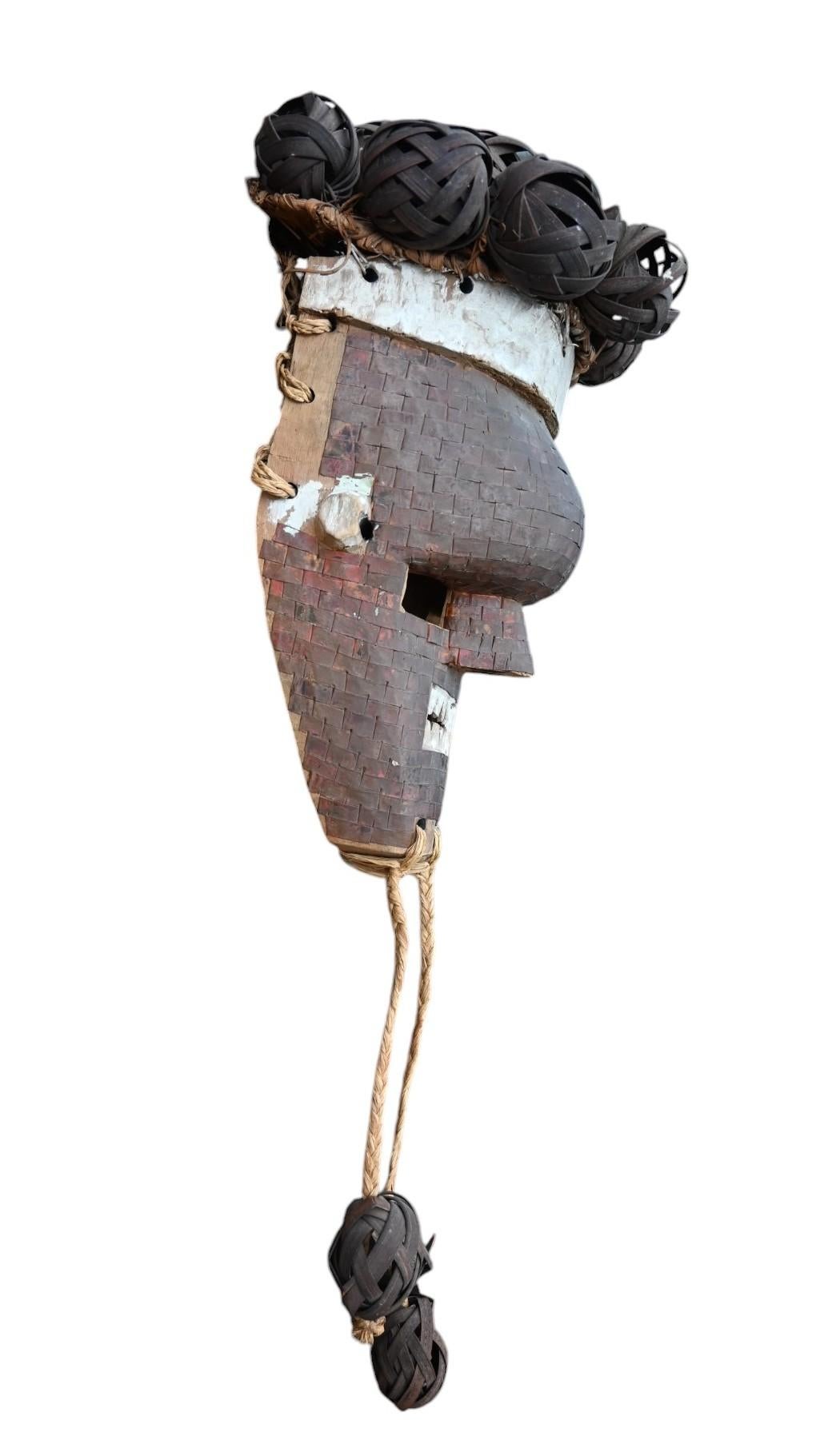 A wooden mask from the Salampasu tribe called Mukinka.
The mask is covered with copper pieces from 1 x 2 cm and has a beard in vegetal fiber, the top of the head is also covered with fiber balls
the Salampasu were located on east of the Kasai River,