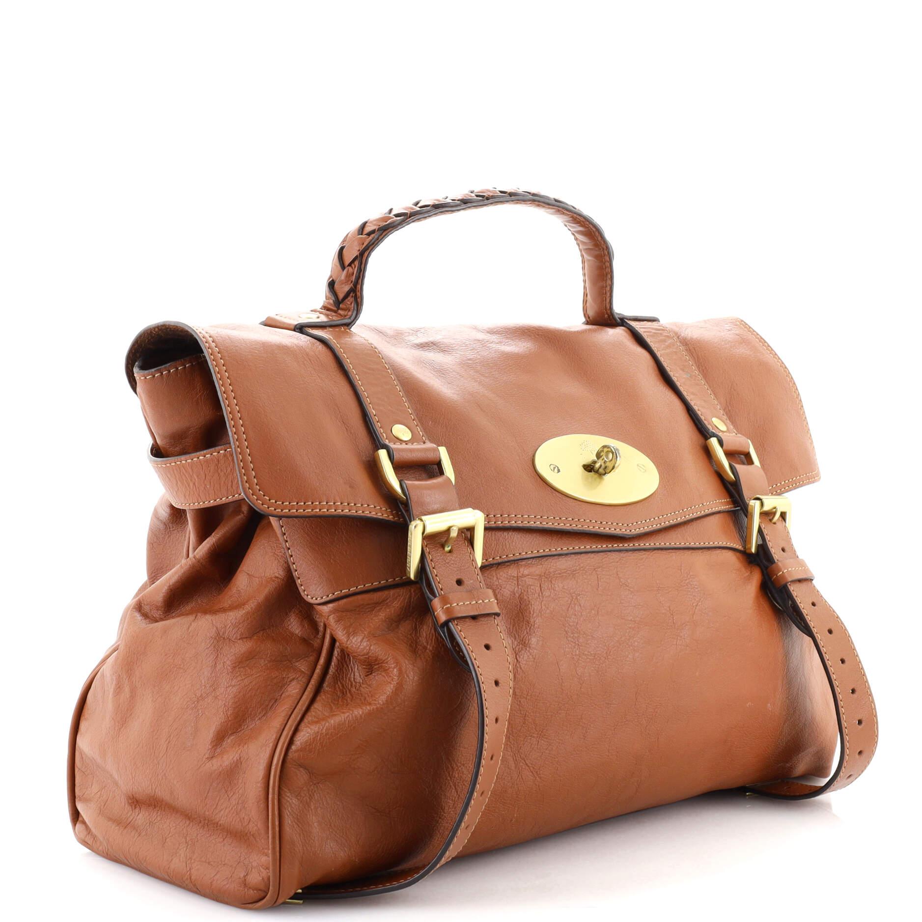 Condition: Good. Odor in interior. Creasing, darkening, moderate wear and scuffs on exterior, handle and strap, cracking on handle base, flap and side opening wax edges. Small marks and wear in interior, scratches and discoloration on
