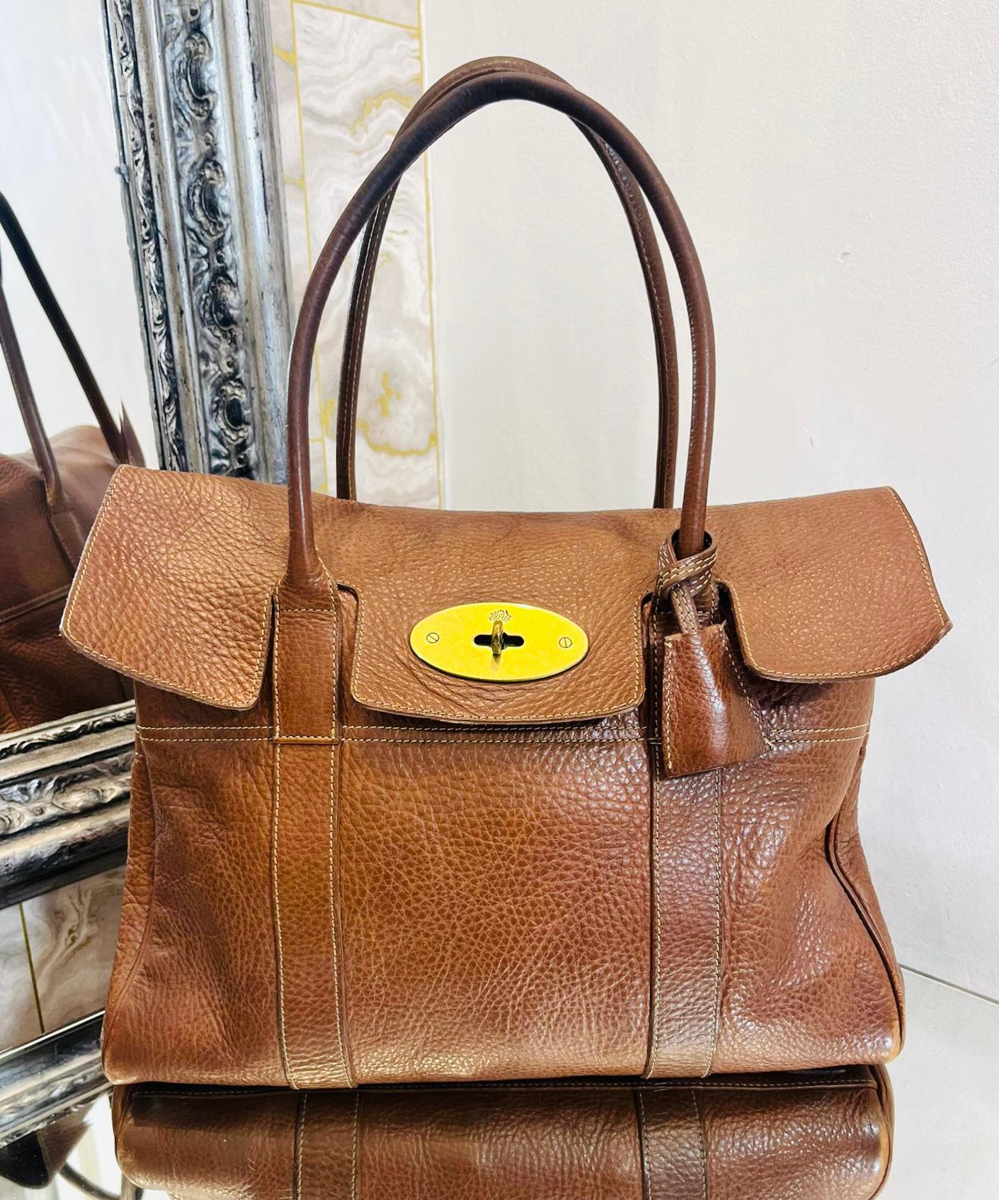 Mulberry Bayswater Leather Bag 

Brown, timeless bag designed with gold, iconic Postman’s Lock and flap closure. 

Detailed with hanging leather fob with hidden padlock and dual rolled top handles.

Featuring spacious interior with adjustable,