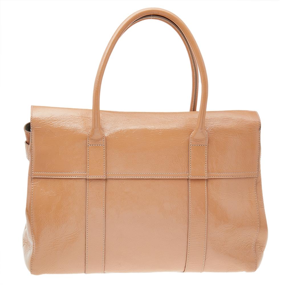 The Bayswater is one of the most well-known collections from Mulberry, so it's fair to say that this satchel is worth the buy. Crafted from beige crinkled leather, the bag is equipped with two handles and a turn lock on the flap securing a capacious