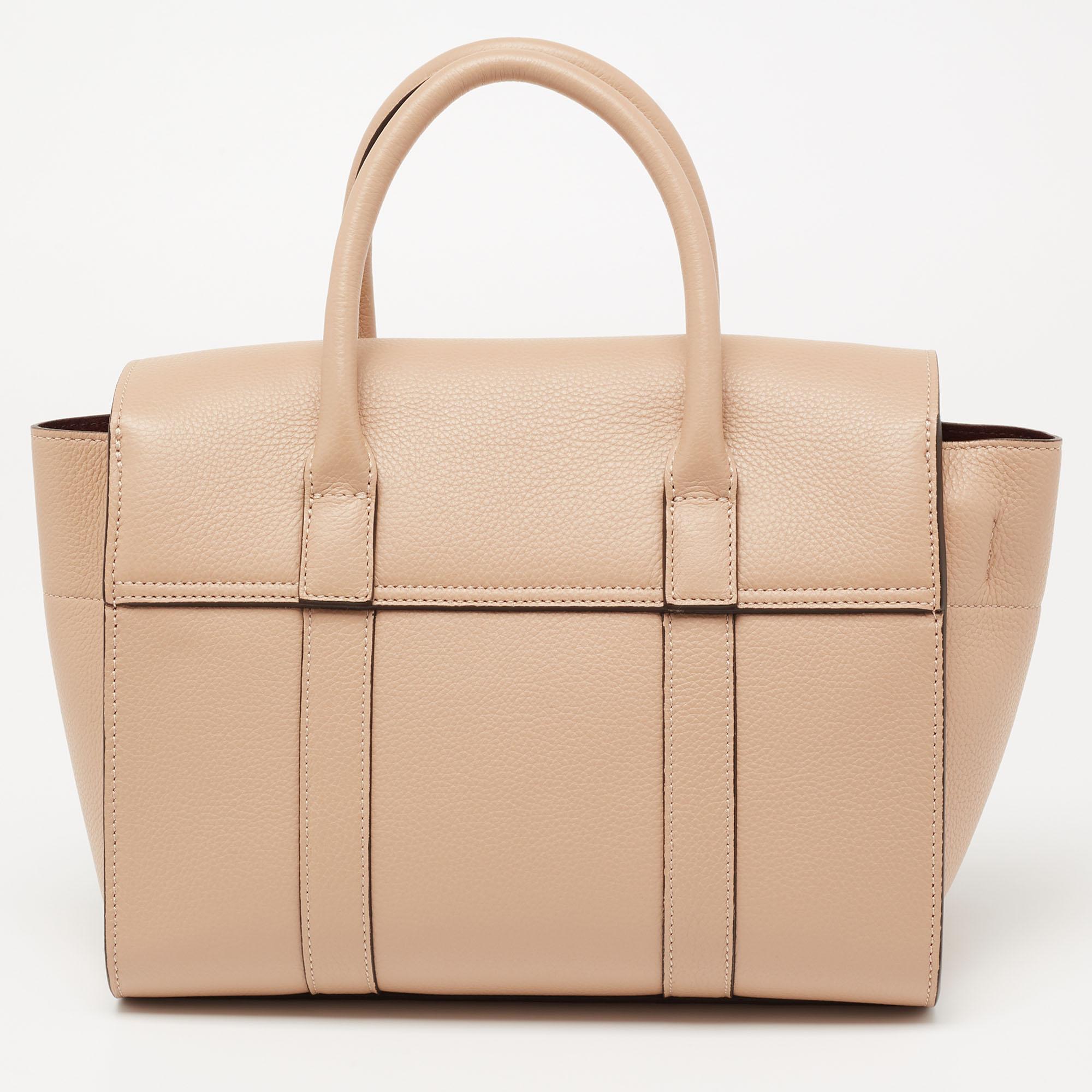 The Bayswater is one of the most well-known collections from Mulberry, so it's fair to say that this satchel is worth the buy. Crafted from beige leather, the bag is equipped with two handles and a turn lock on the flap securing a capacious interior