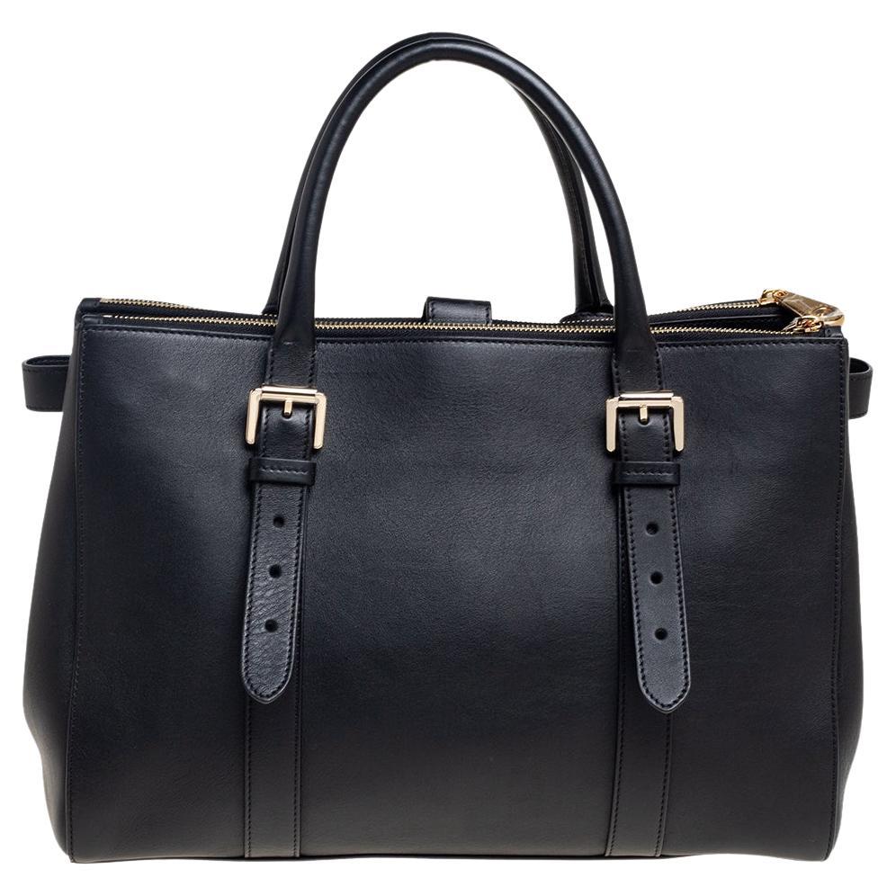 This Bayswater tote from Mulberry is designed to bring elegance and luxury to every woman. It is crafted from black leather, with a gold-toned logo lock closure placed on the front. Along with a sturdy shape, this tote comes with dual handles, a