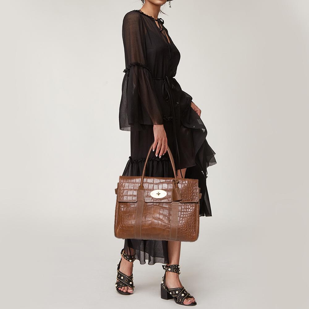 The Bayswater is one of the most well-known collections from Mulberry, so it's fair to say that this satchel is worth the buy. Crafted from brown croc-embossed leather, the bag is equipped with two handles and a turn lock on the flap securing a