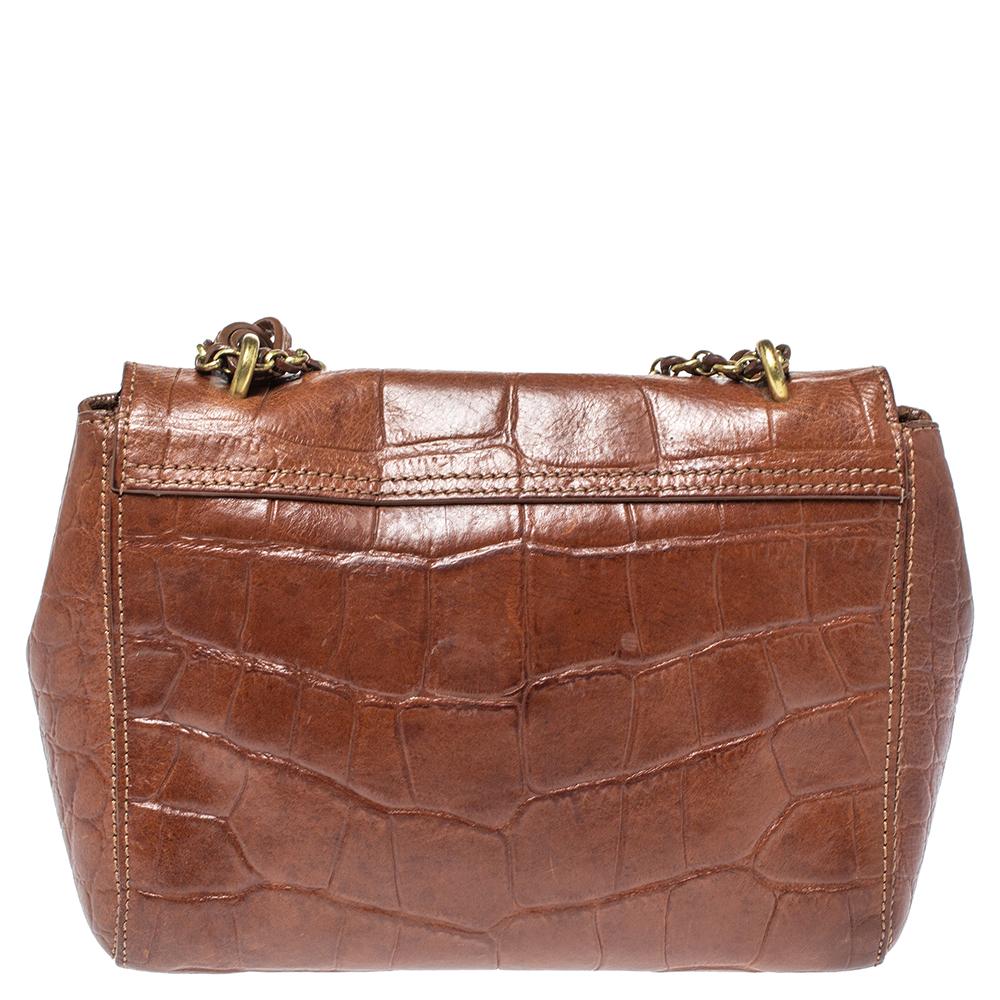 This Mulberry Lily bag is lovely. Crafted from croc-embossed leather, the brown bag comes with a chain and leather woven strap, a postman's lock on the flap, and a suede-lined interior. It is ideal for everyday use. It is impeccably finished with