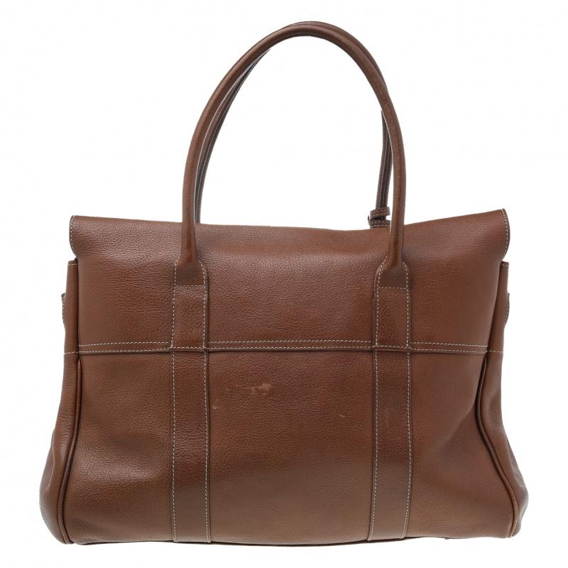 This celebrity-coveted Bayswater handbag by Mulberry is timeless. This version is crafted from leather that features the well-known Postman’s lock closure in gold-tone hardware, leather handles, and a spacious leather-lined interior that features a