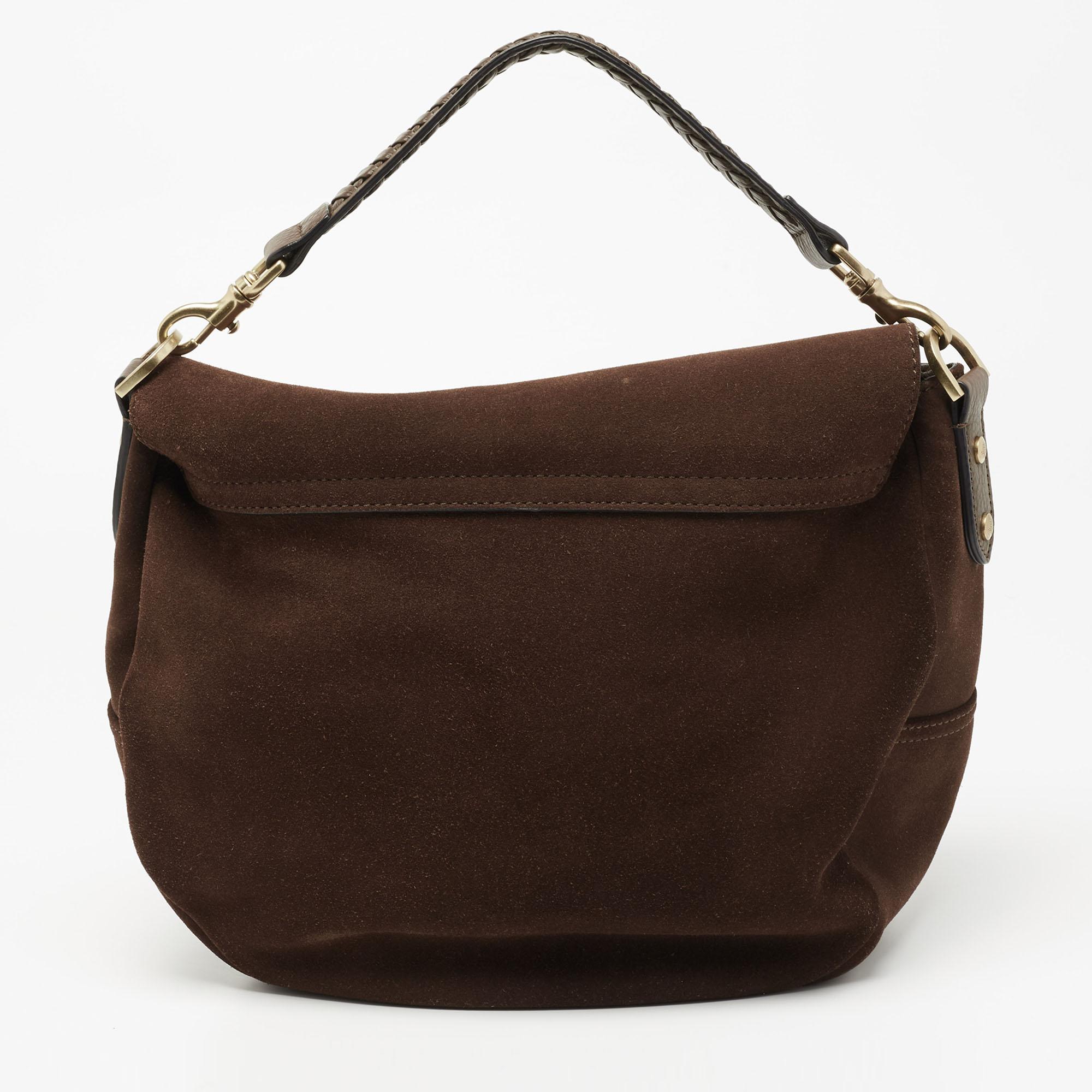 Easy to carry and stylish in appearance, this Effie satchel from Mulberry will certainly be your favorite pick this season. It is crafted using dark-brown suede and leather, with gold-tone hardware elevating its beauty. It provides two handles and a