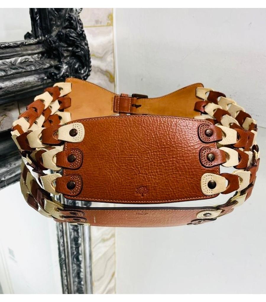 Mulberry Leather Cinch Belt

Brown wide belt designed with triple braided stripes to the sides in white and brown.

Detailed with brown buckle closure and signature 'Tree' logo engravement to the front studs.

Size – 102cm

Condition – Very
