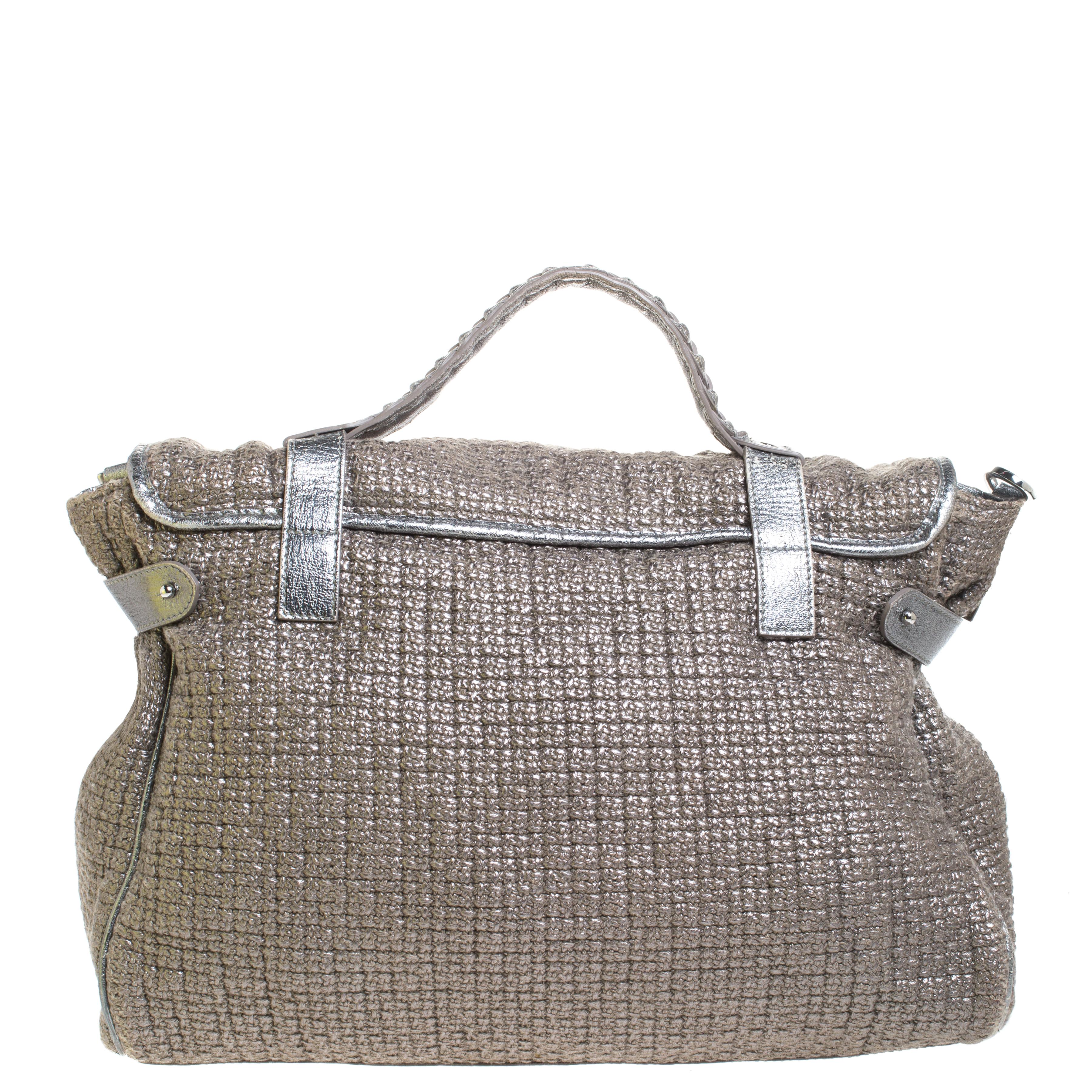 Mulberry brings you this handy bag that will dutifully support you wherever you go. It has been made from woven fabric and leather and equipped with a twist lock on the flap that secures a spacious fabric interior capable of holding all your