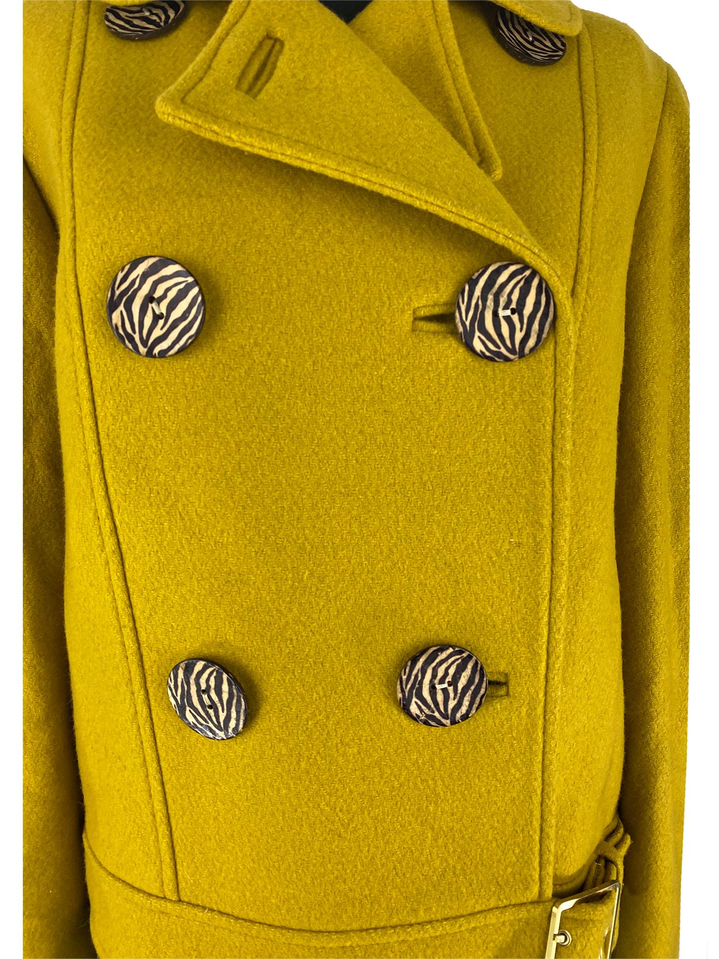 A contemporary Mulberry woollen jacket in mustard yellow. This jacket has been inspired by bikers’ jackets, mimicking the belt and buckle at the hem and the single notch collar paired with the double-breasted bodice. The jacket is fastened with