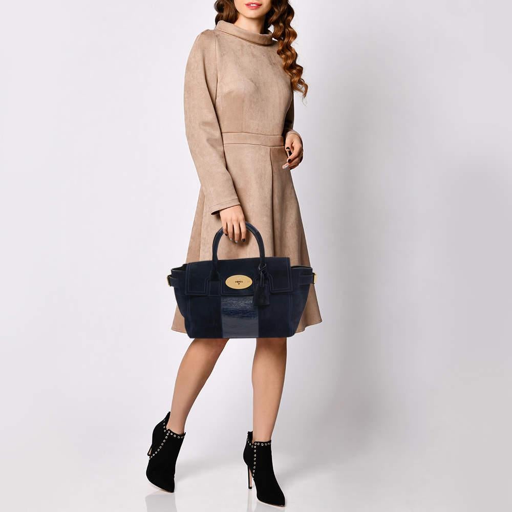 The Bayswater is one of the most well-known collections from Mulberry, so it's fair to say that this satchel is worth the buy. Crafted from navy blue suede and leather, the bag is equipped with dual top handles and a turn lock on the flap securing a