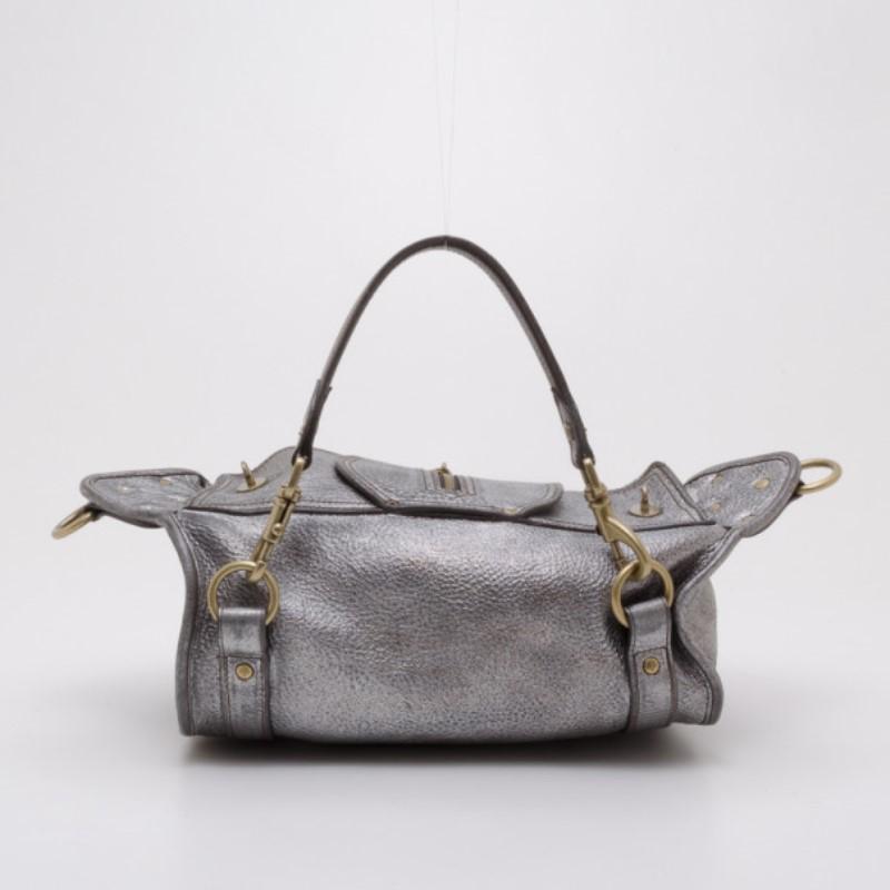 Get through your week in style with this convertible Emmy satchel by Mulberry. Crafted from cool pewter leather, it is boldly accented with buckles, zippers, pockets and brass hardware. The spacious unlined interior features a zip pocket. The Emmy