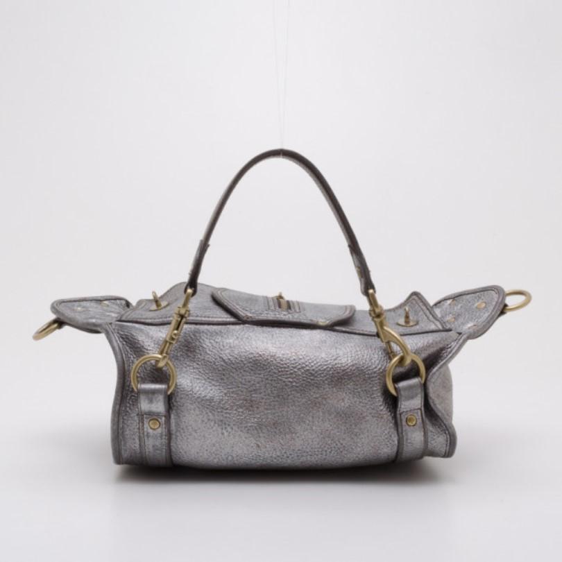 Get through your week in style with this convertible Emmy satchel by Mulberry. Crafted from cool pewter leather, it is boldly accented with buckles, zippers, pockets and brass hardware. The spacious unlined interior features a zip pocket. The Emmy