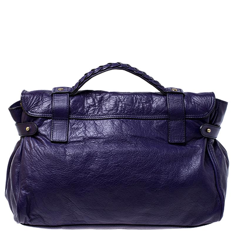Mulberry brings you this handy bag that will dutifully support you wherever you go. It has been crafted from leather in a purple shade and equipped with a twist lock on the flap that secures a spacious fabric interior capable of holding all your