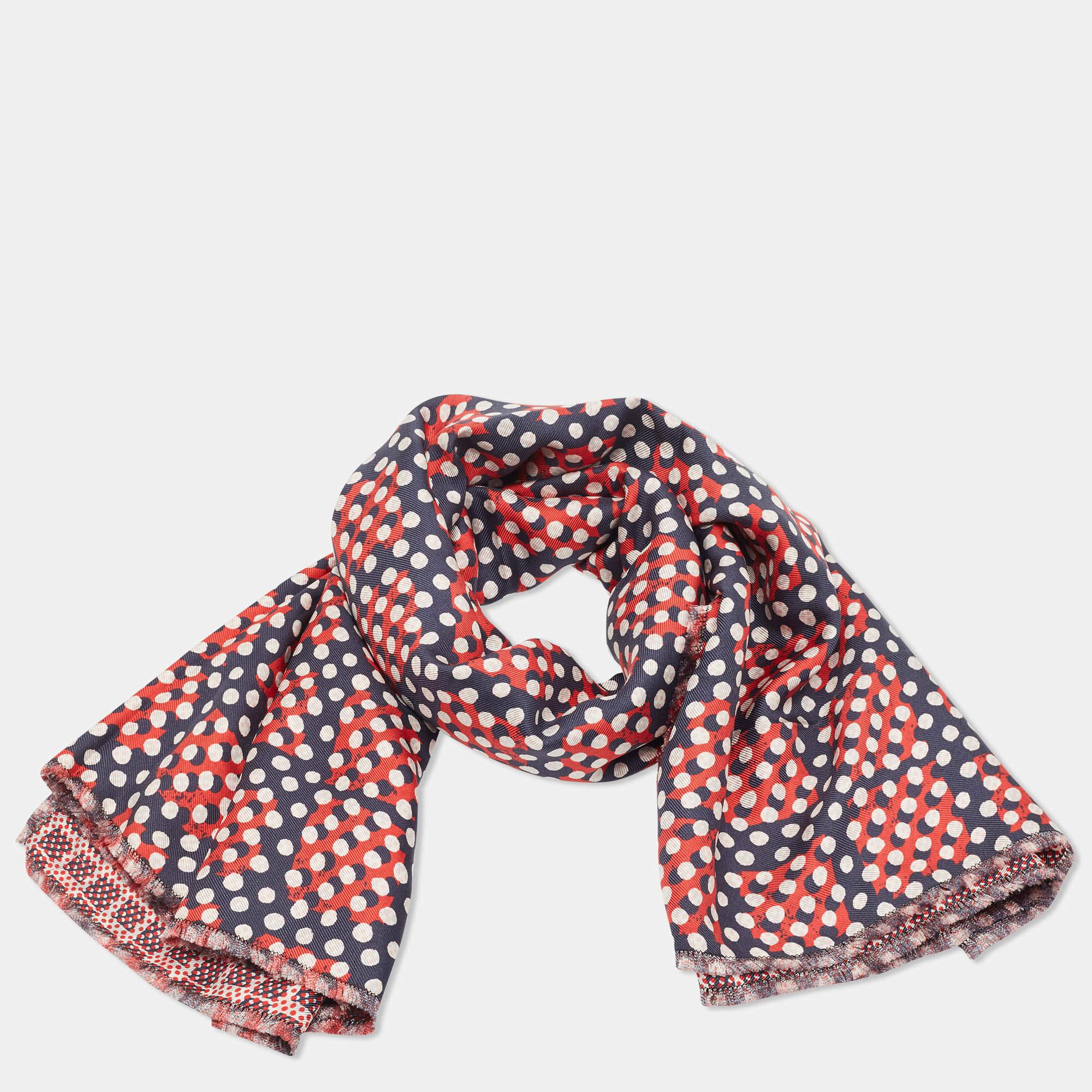 From the house of Mulberry comes this beautiful scarf that's made of silk. It has a square shape and is covered in dot prints of red and blue.