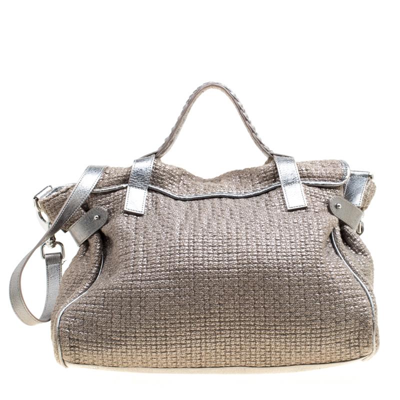 Mulberry brings you this handy bag that will dutifully support you wherever you go. It has been made from woven fabric and leather and equipped with a twist lock on the flap that secures a spacious fabric interior capable of holding all your