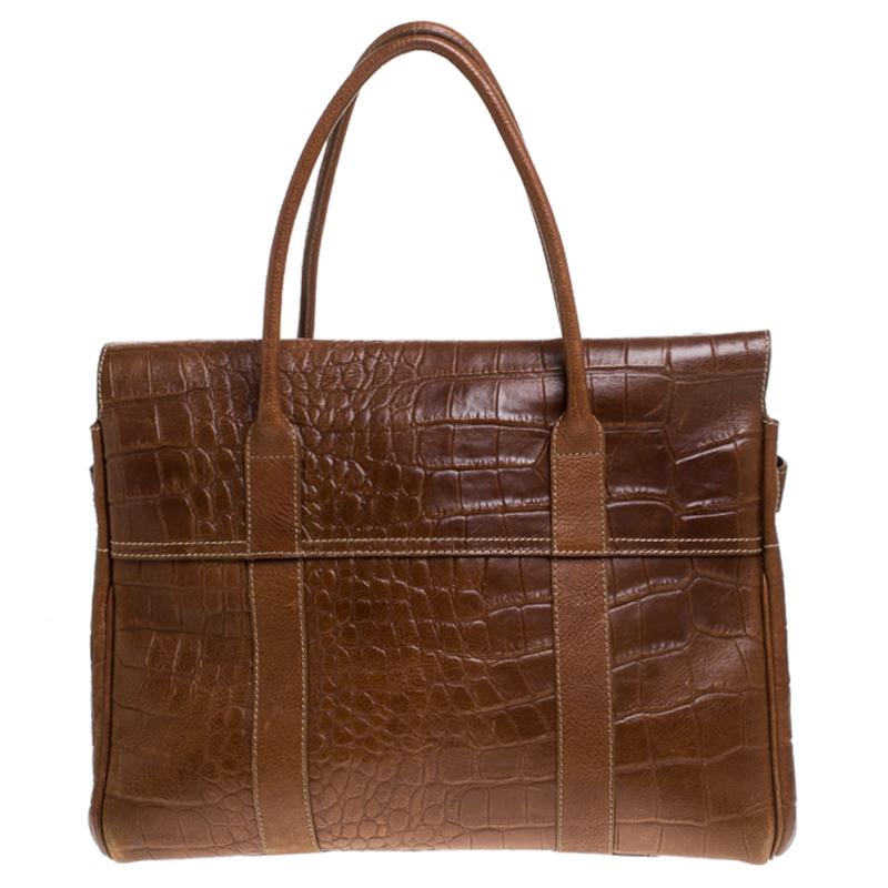 The Bayswater is one of the most well-known collections from Mulberry, so it's fair to say that this satchel is worth the buy. Crafted from tan croc-embossed leather, the bag is equipped with two handles and a turn lock on the flap securing a
