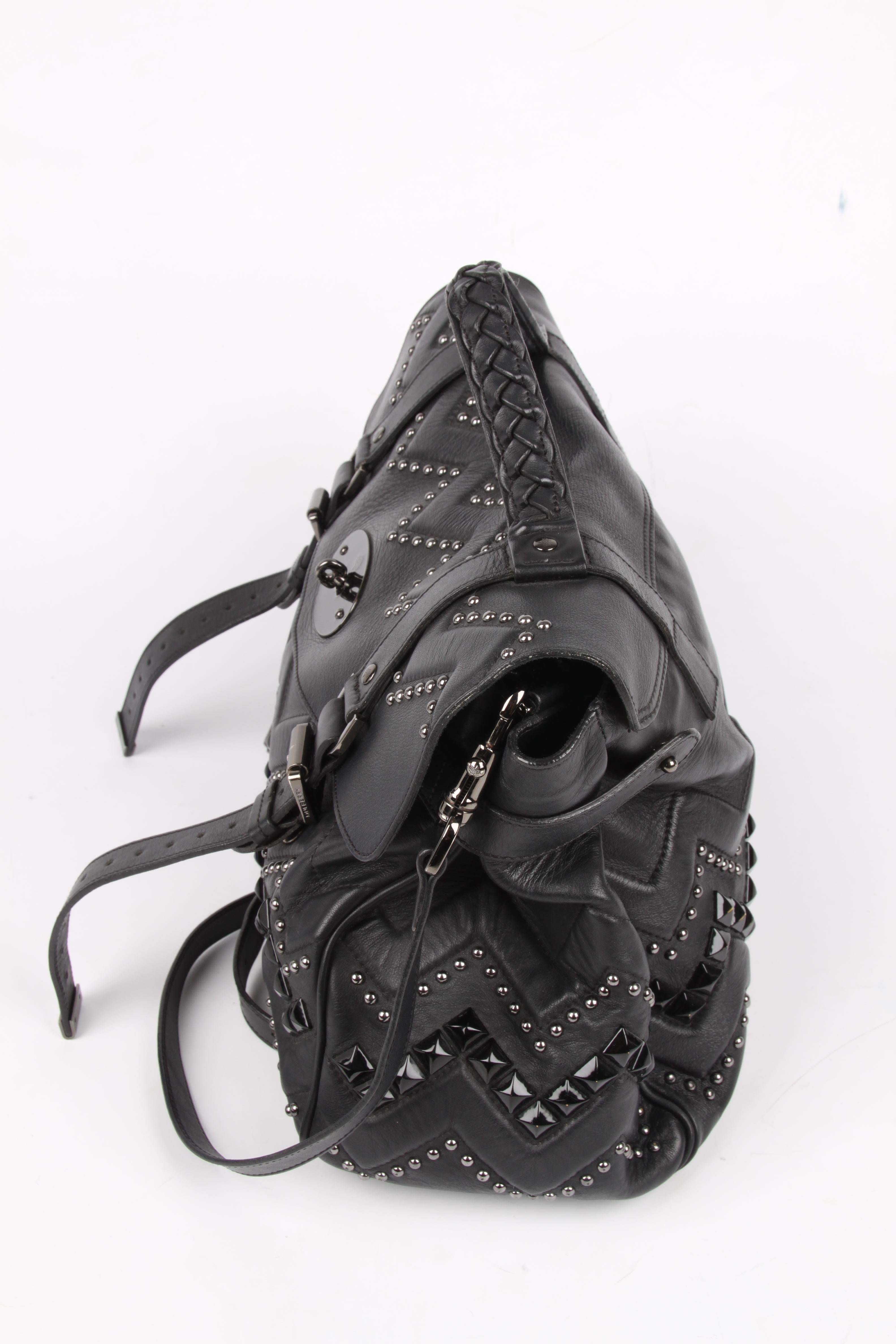 This Mulberry Alexa is crafted from black leather with a geometrical pattern of silver and black studs, that's why it's called Zig Zag. 

Blackish/silver-tone hardware, a long detachable shoulder strap and a braided handle on top. No lining, two