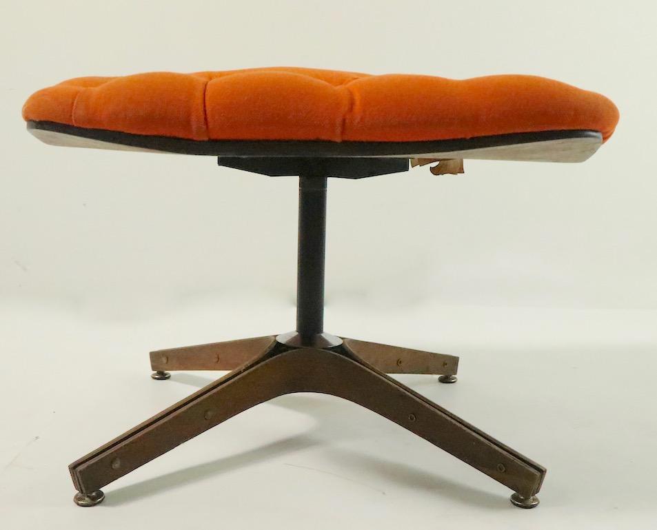 Iconic midcentury swivel, tilt lounge chair and ottoman of bent plywood and tufted upholstery. This example is in good structural condition, the fabric is worn and will need to be replaced. Designed by George Mulhauser for Plycraft, this chair shows