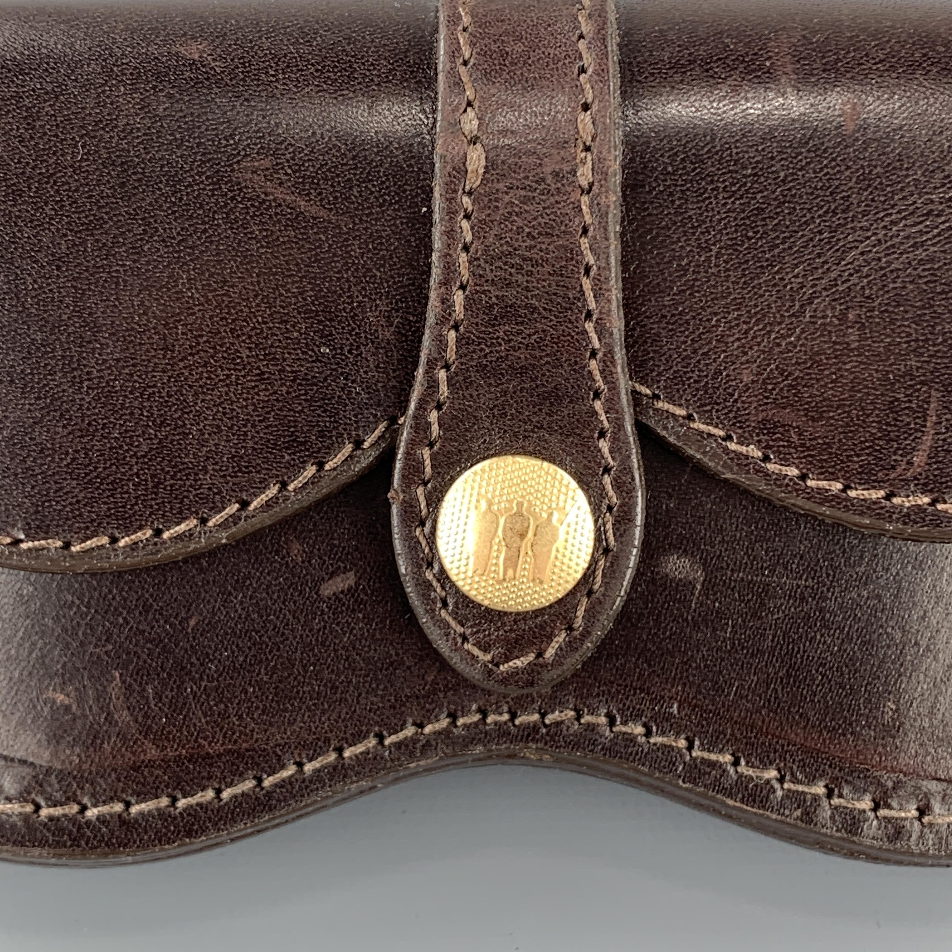 Vintage MULHOLLAND BROTHERS eyewear case comes in dark brown structured leather with a snap flap closure detailed with gold tone engraved snaps and back snaps to attach to belt strap. Wear throughout. Hand Made in USA.

Good Pre-Owned