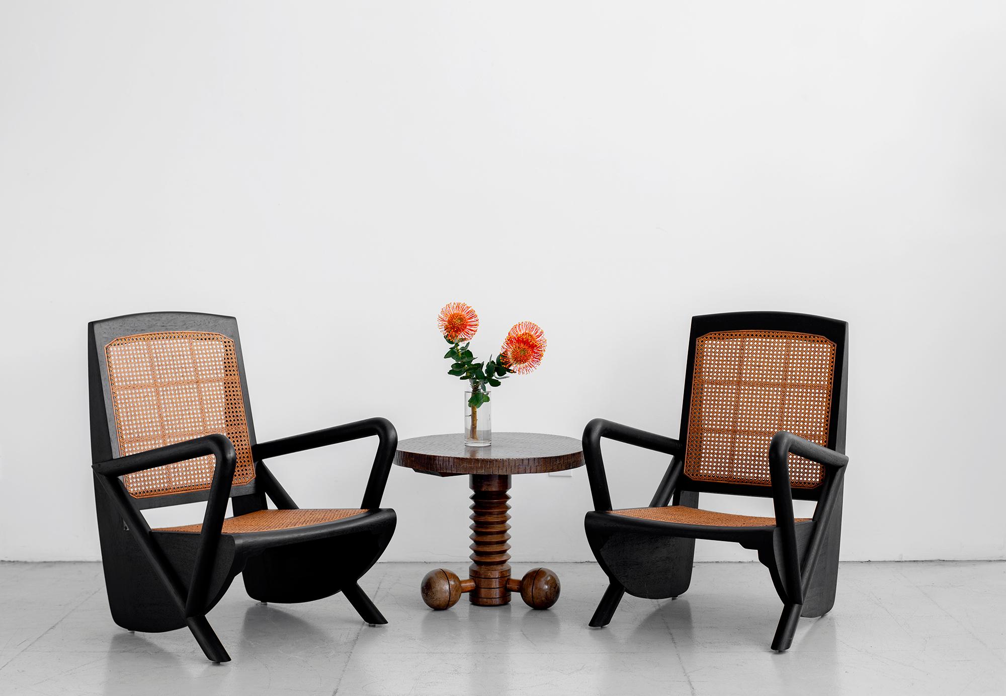 Gorgeous pair of teak and caned chairs based on a French design. Newly produced with wonderful lines. Caned seat and back and refinished in ebony.

