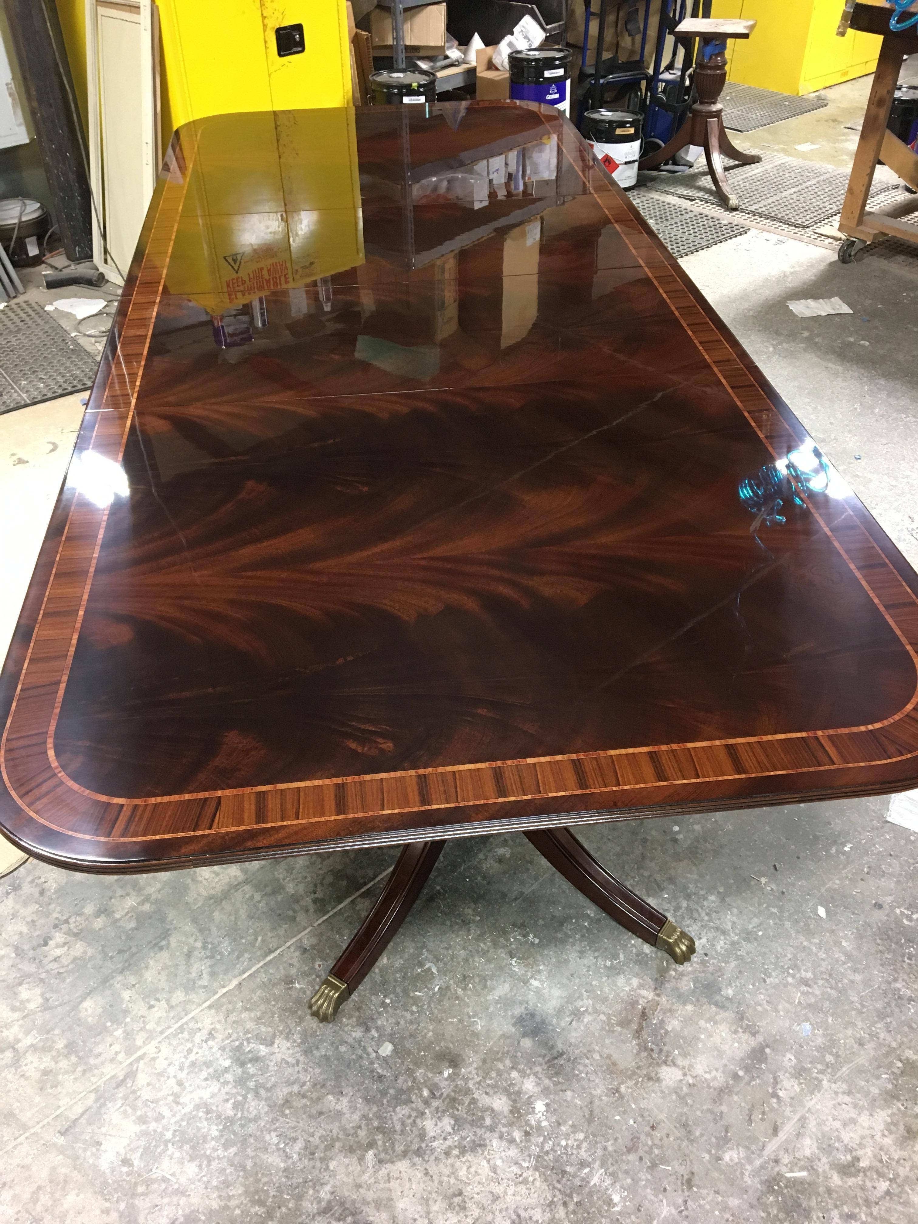This is a made-to-order Large Traditional mahogany banquet/dining table made in the Leighton Hall shop. It features a field of slip-matched swirly crotch mahogany from west Africa and santos rosewood and crotch mahogany borders. It has a hand rubbed
