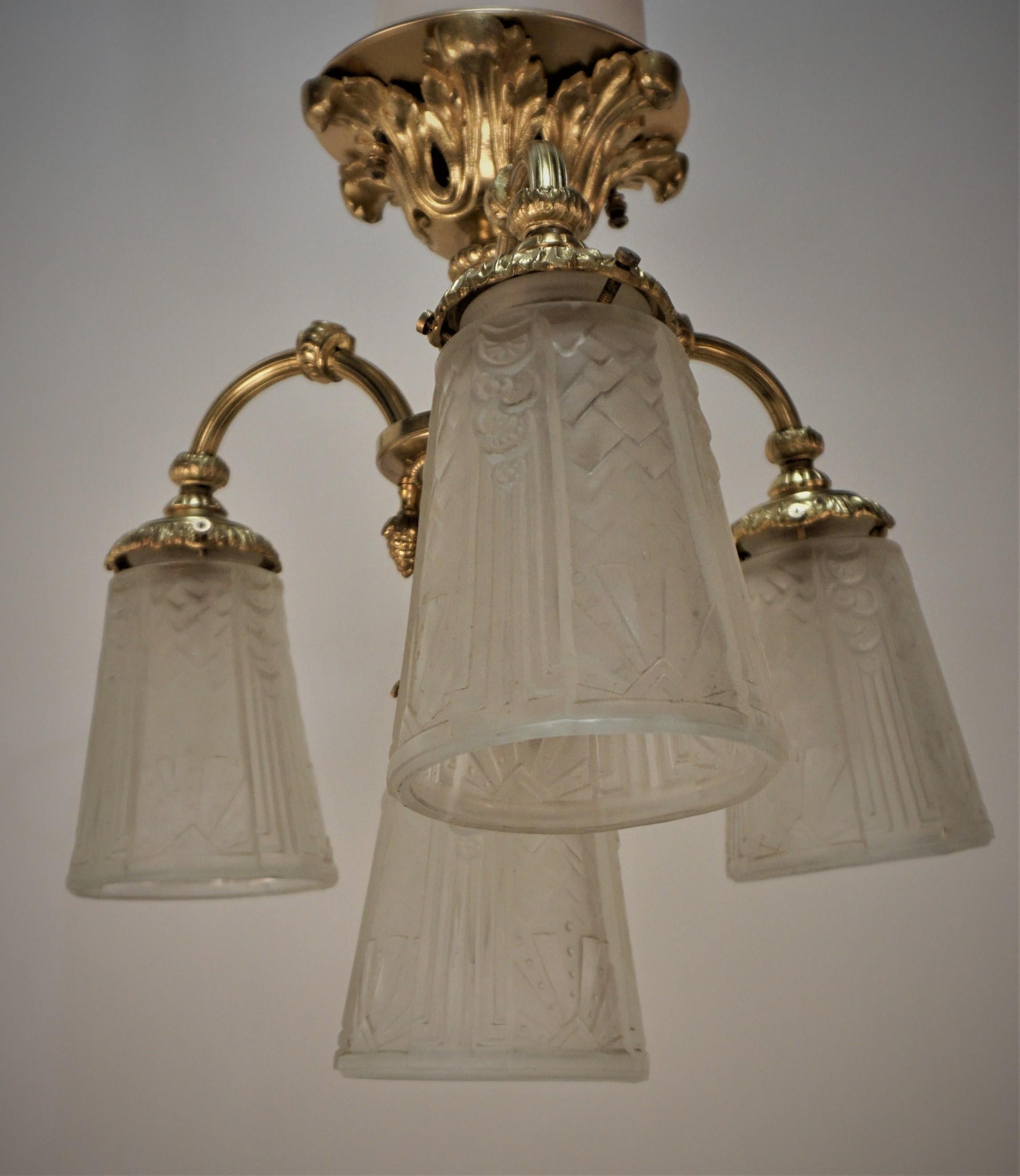 Semi flush mount bronze chandelier with clear frost glass shades by Muller Freres. 
Four lights, 75watts max each.