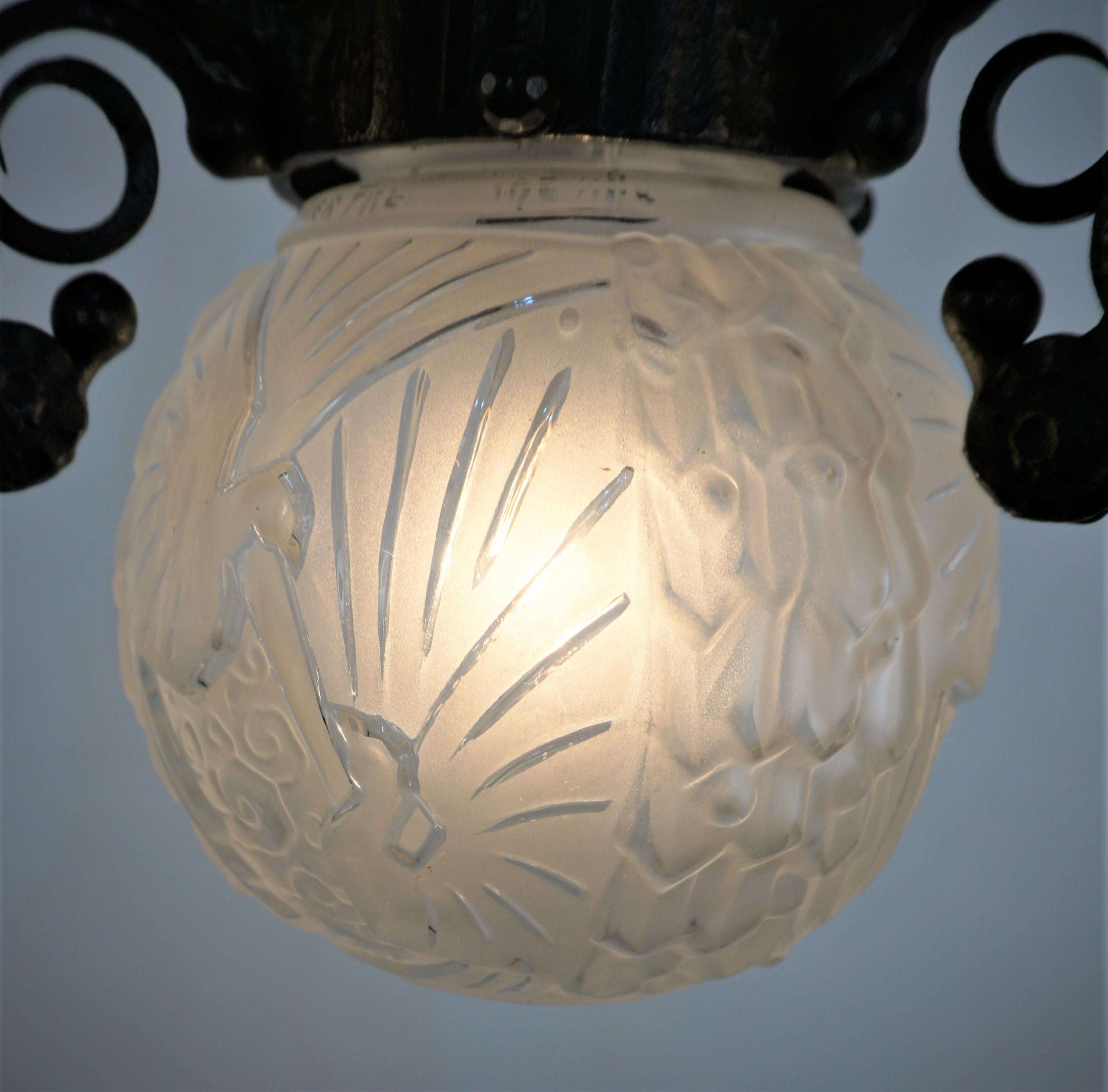 Clear frost glass in geometric peacock design art deco chandelier with beautiful, handcrafted iron frame.
Professionally rewired and ready for installation.  