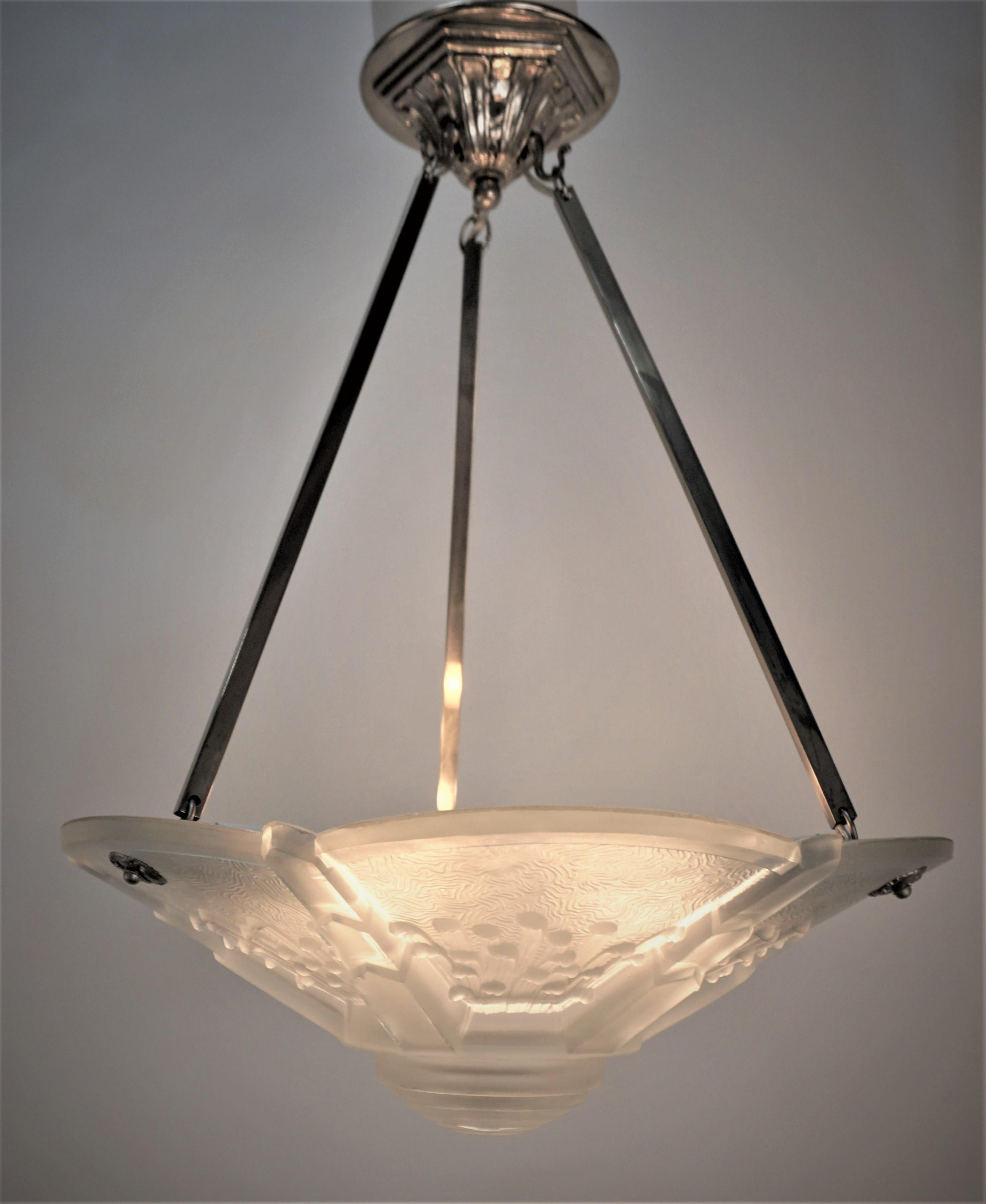 Beautiful design clear frost glass wit high light polish, polished nickel on bronze hardware art deco chandelier by Muller Freres.
Professionally rewired with six lights, 60watts each.