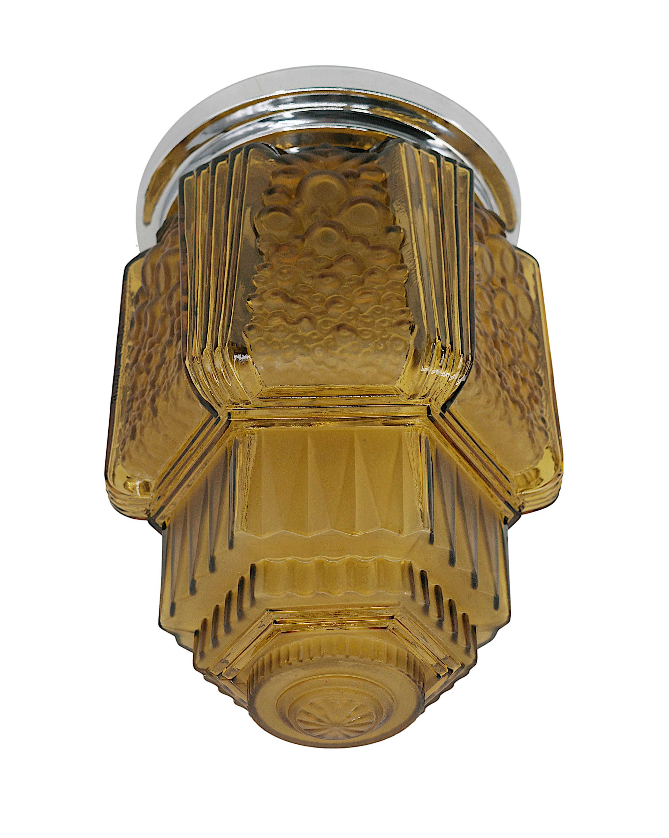 French Art Deco  flush mount by MULLER FRERES (Luneville) for Francis HUBENS (decoration house), 68 rue des Archives, Paris, 3e, France, ca.1920. Glass and chrome. Art Deco ceiling light in the shape of an inverted skyscraper. Dark amber color.