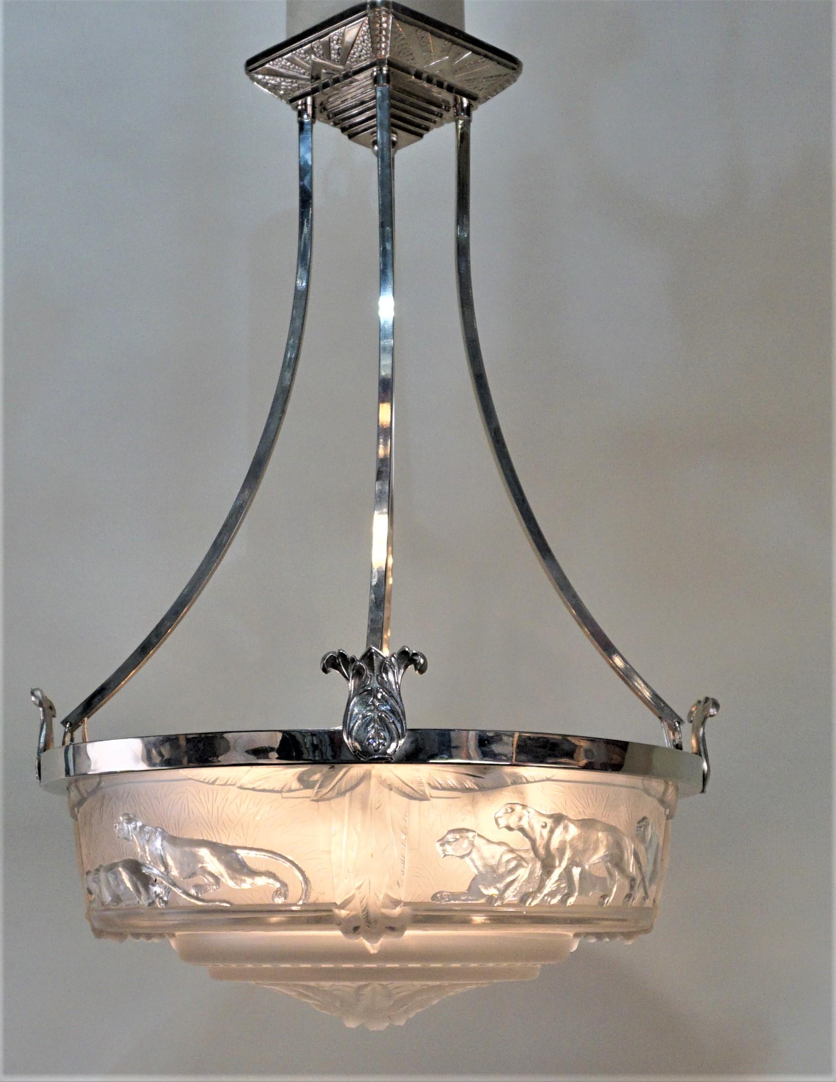 Frost glass in clear and frost features panthers, nickel on bronze frame chandelier.
Height can be adjusted by cutting the rods.
Eight lights 60 watts max each.