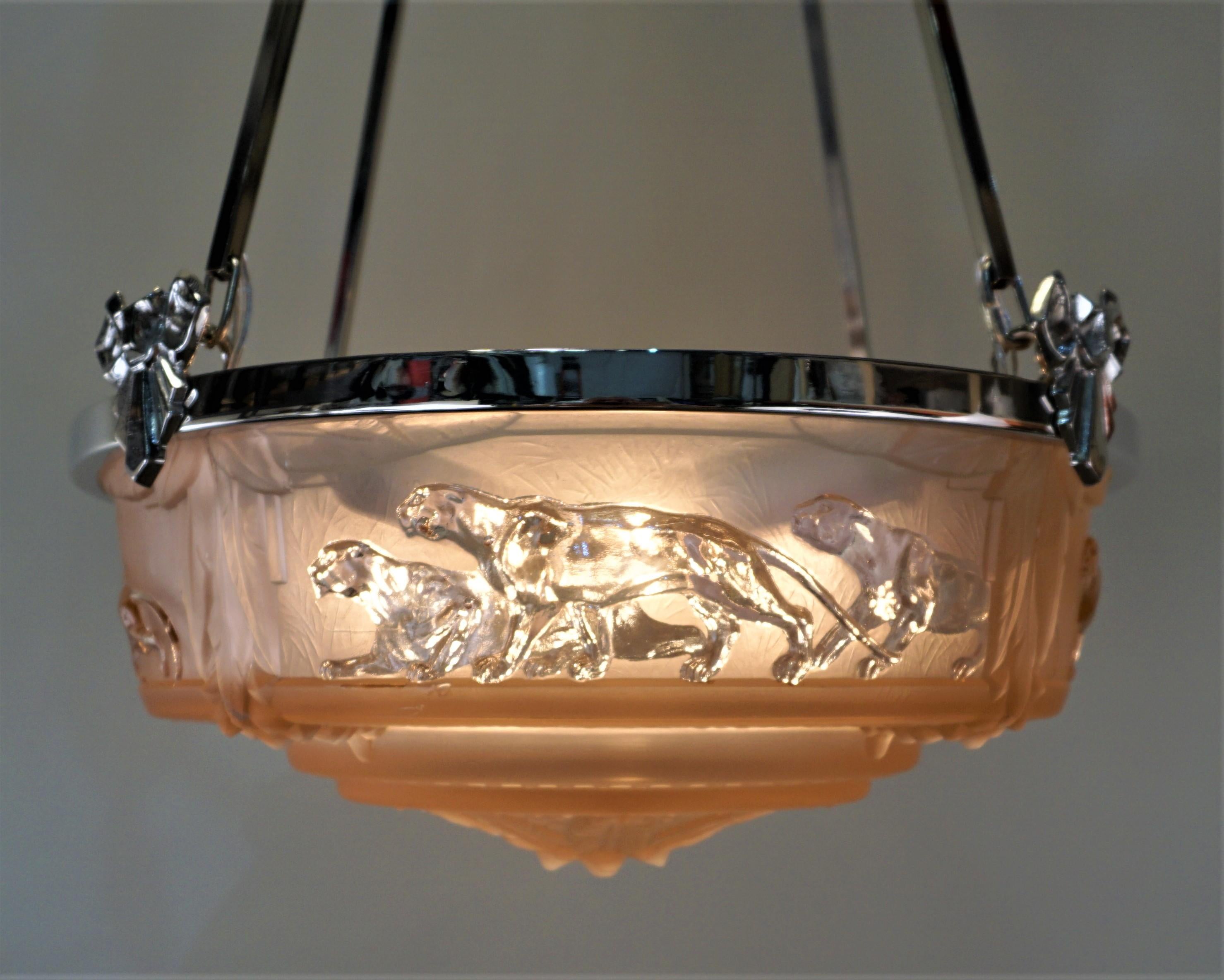 Pink glass in clear and Frost features panthers, nickel on bronze frame chandelier.
Height can be adjusted by cutting the rods.