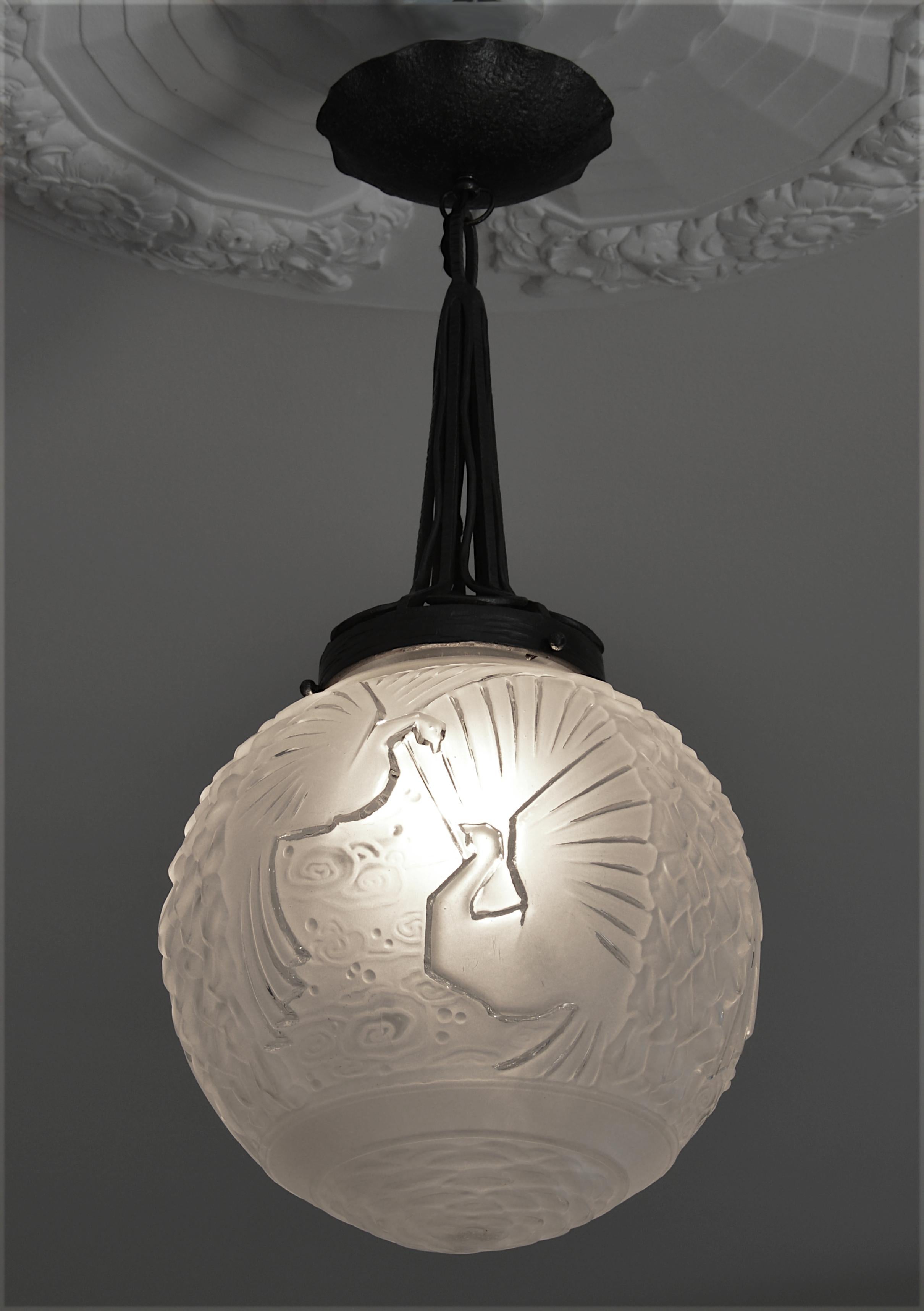French Art Deco ceiling-light by Muller Freres (Luneville), France, ca.1925. Glass and wrought-iron. Thick and large frosted glass shade with its wrought-iron fixture. 6 paradise birds in the sky. Measures: Height: 23.6