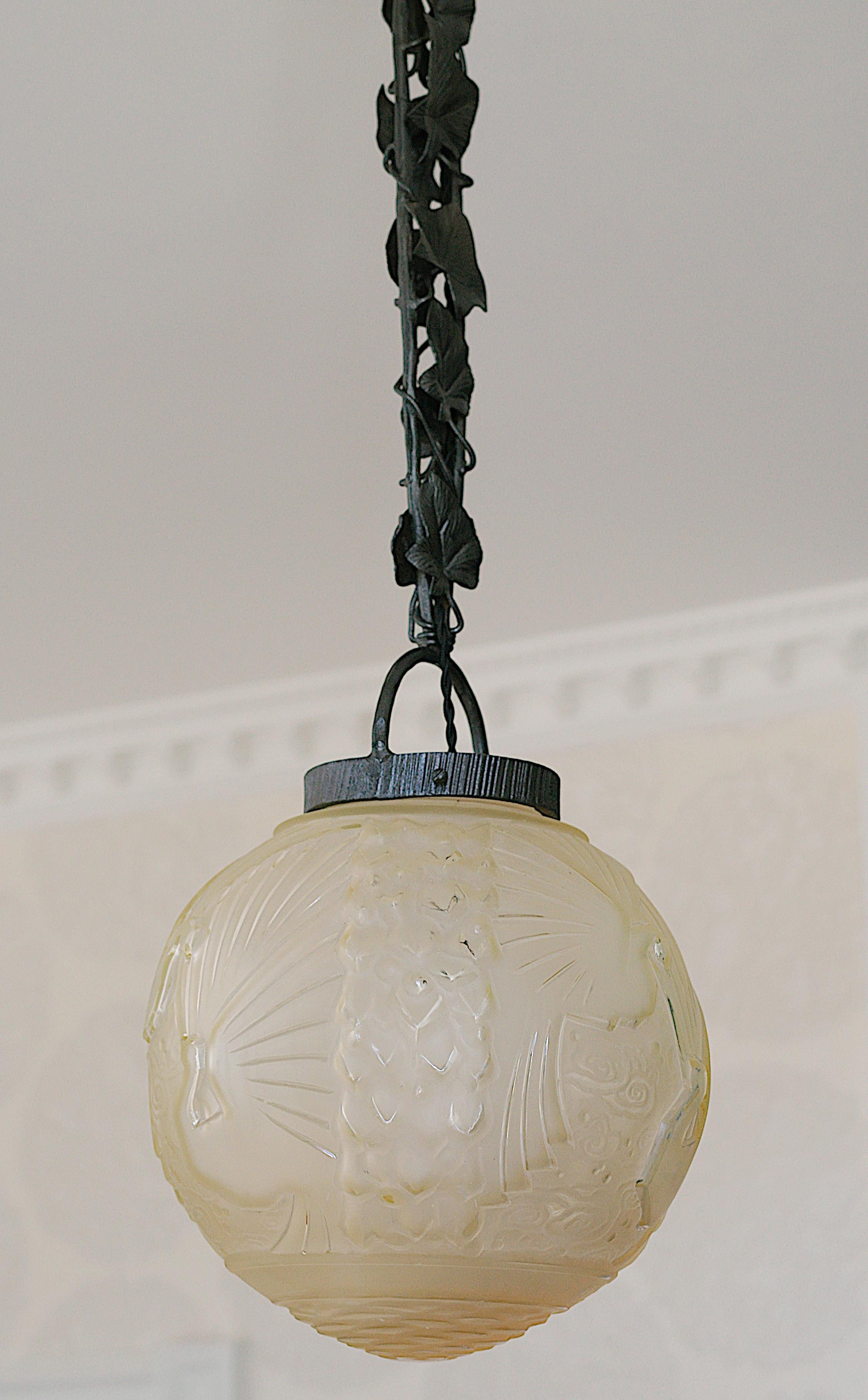 French Art Deco ceiling-light by Muller Frères (Luneville), France, ca.1925. Thick and large frosted glass shade with its wrought-iron ivy fixture. 6 paradise birds in the sky. Slightly beige or pink depending on the light. Measures: Height :