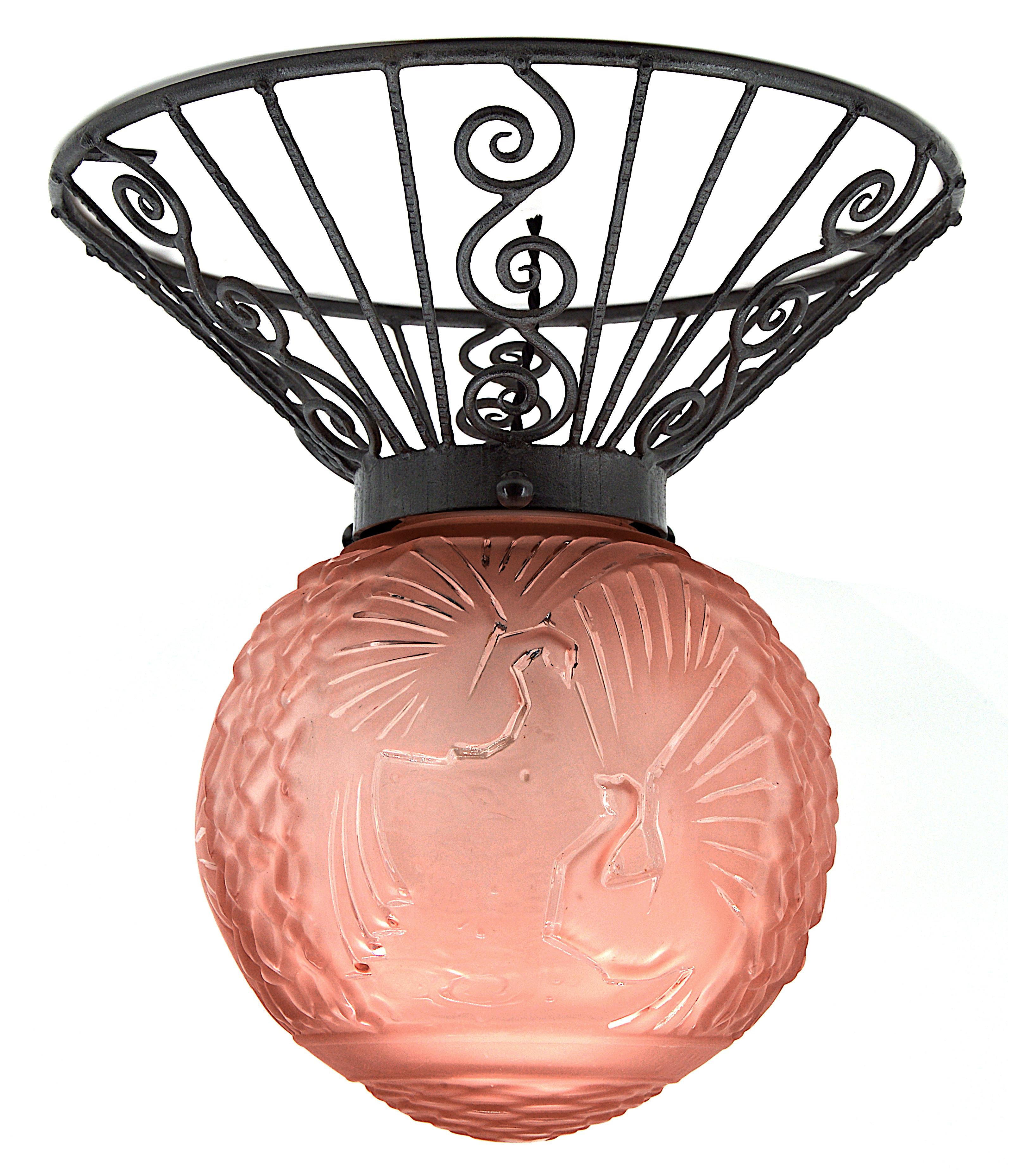 French Art Deco flushmount by Muller Frères (Luneville), France, early 1920s. Thick and large pink frosted glass shade with its iron fixture. 6 paradise birds in the sky. Measures: Height 15.5