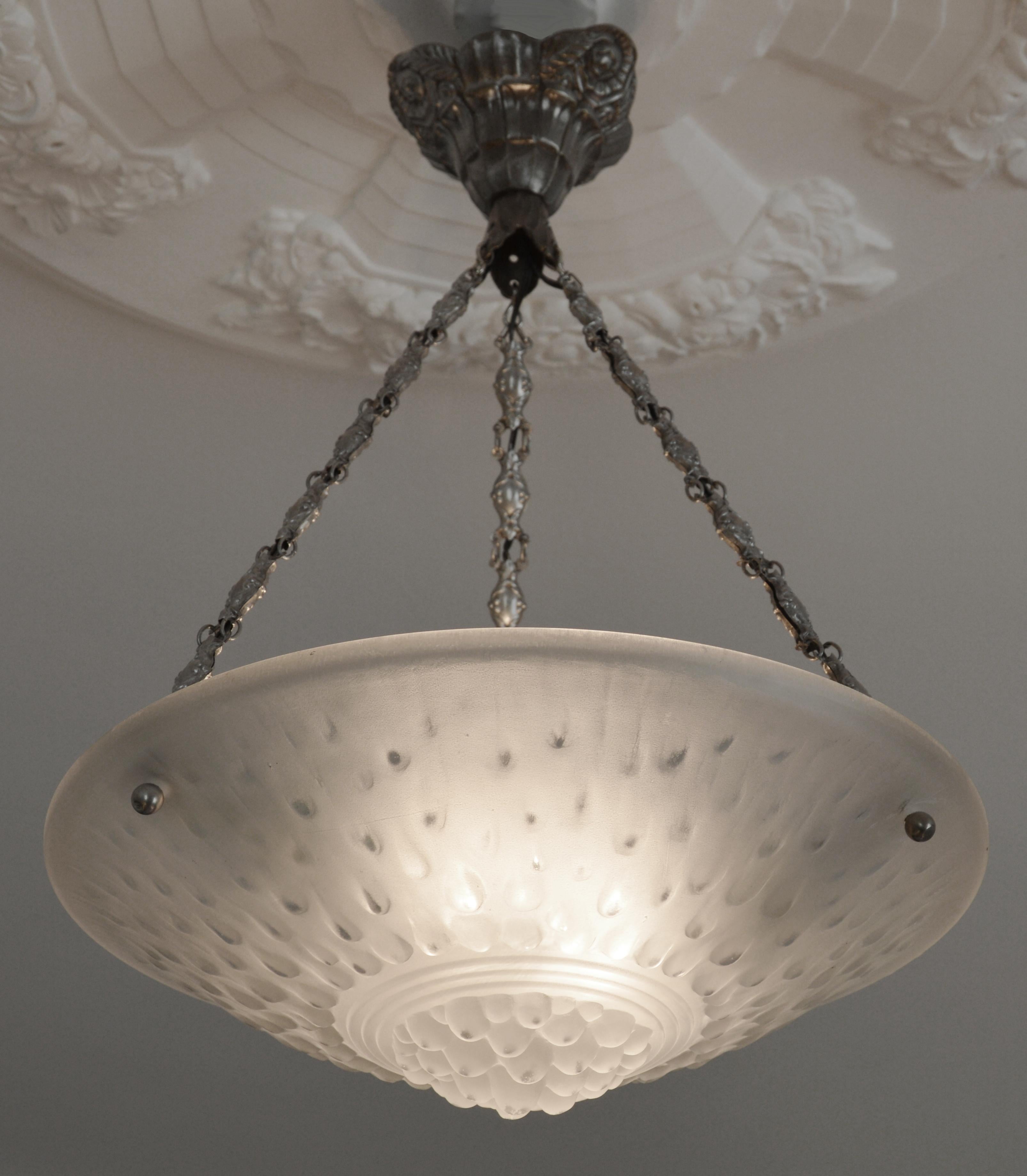 Art Deco pendant chandelier by Muller Freres (Luneville), France, 1920s. Glass, bronze and brass. White frosted molded-pressed glass shade. It comes with its nice period silver plated solid bronze (canopy) and stamped brass (chains) fixture.