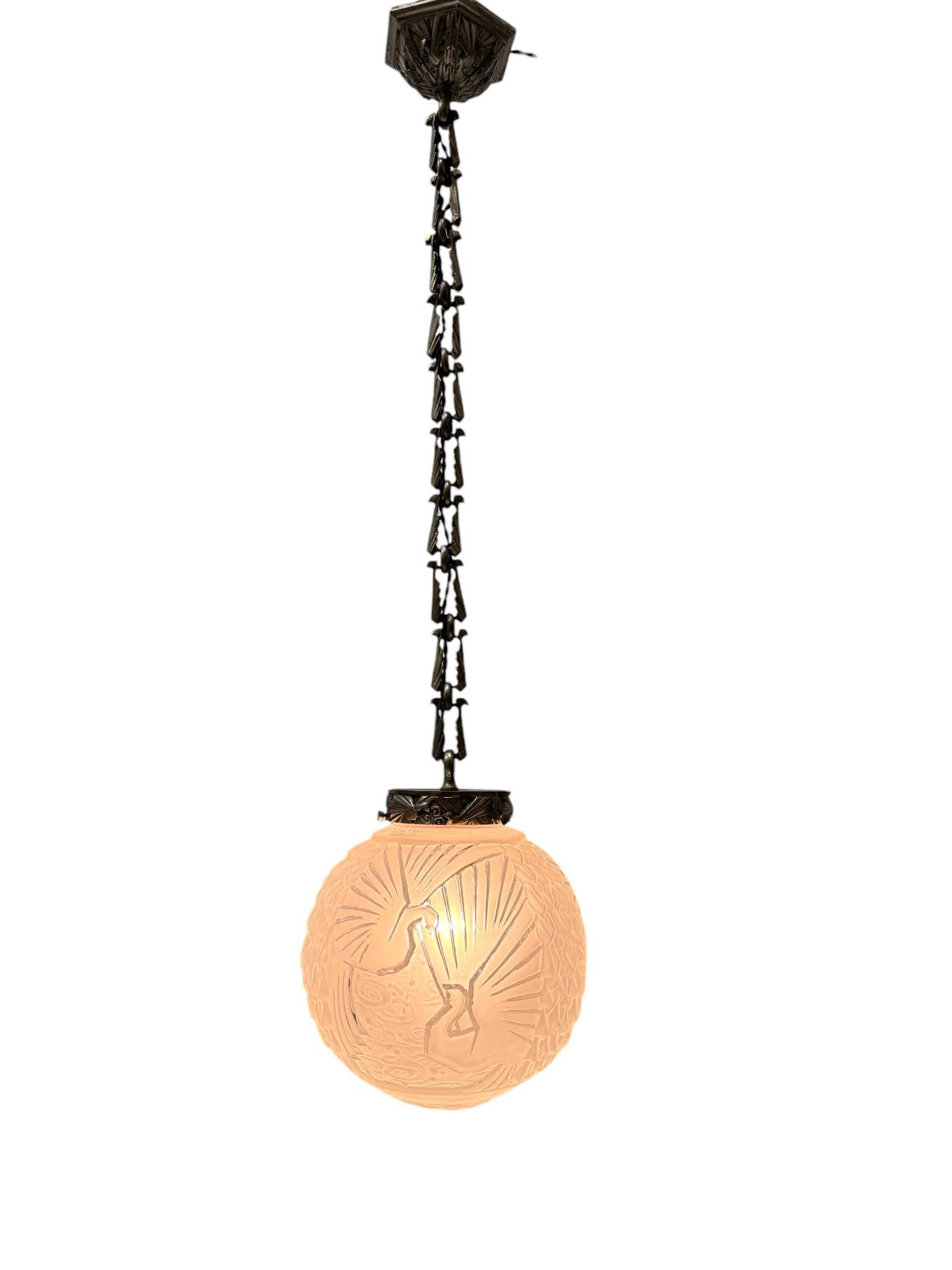 Magnificent and rare Art Deco pendant light.
Design by Muller Frères Luneville.
Striking French design from the 1930s.
Original silver plated bronze ceiling plate, chain and holder for the shade with original decorative elements and also peacocks as