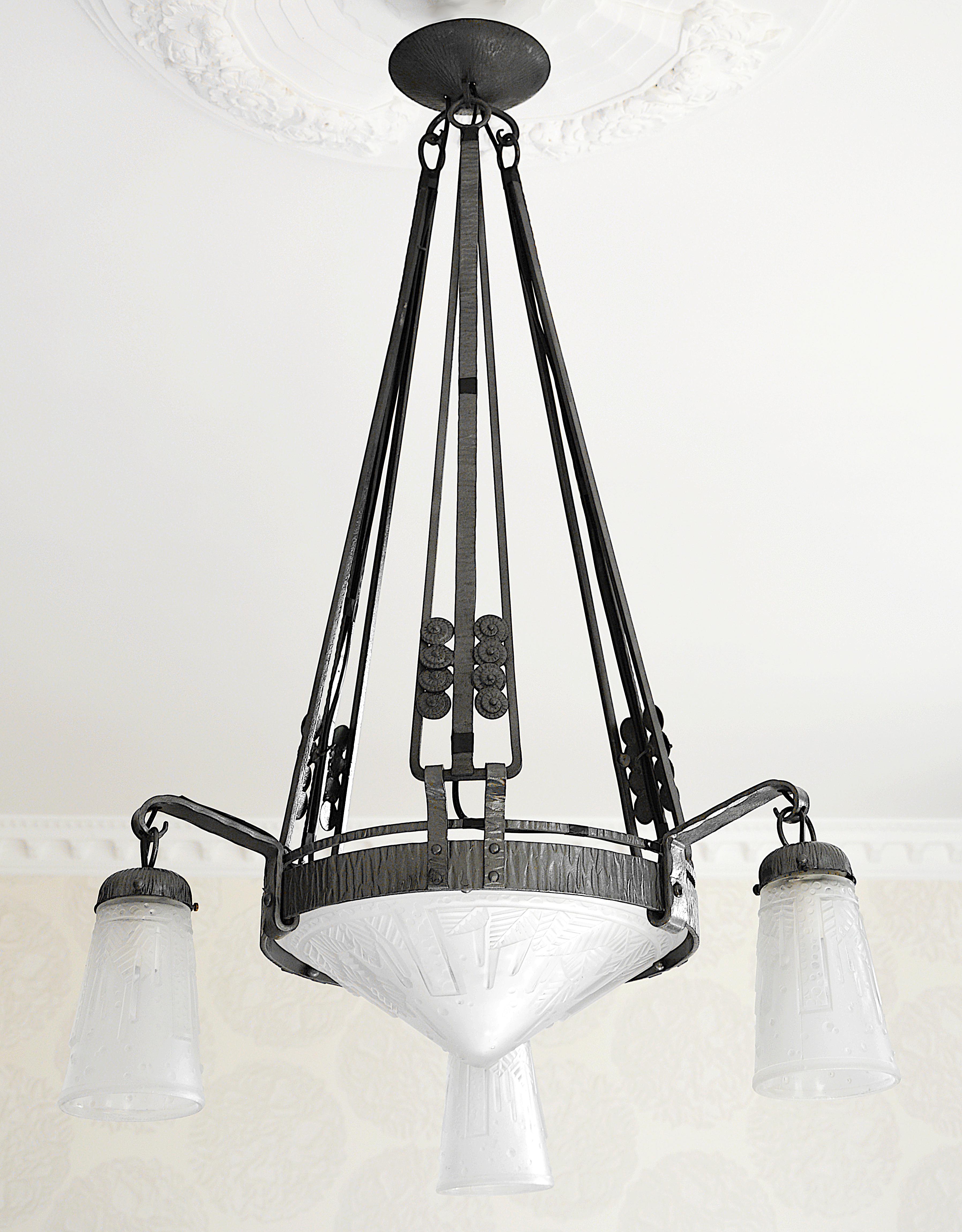 Large French Art Deco chandelier by Muller Freres (Luneville), France, circa 1925. Frosted molded glass shades with a stylized banana tree pattern. Superb wrought-iron fixture by Marcel VASSEUR (Paris). Measures: Height 36.6