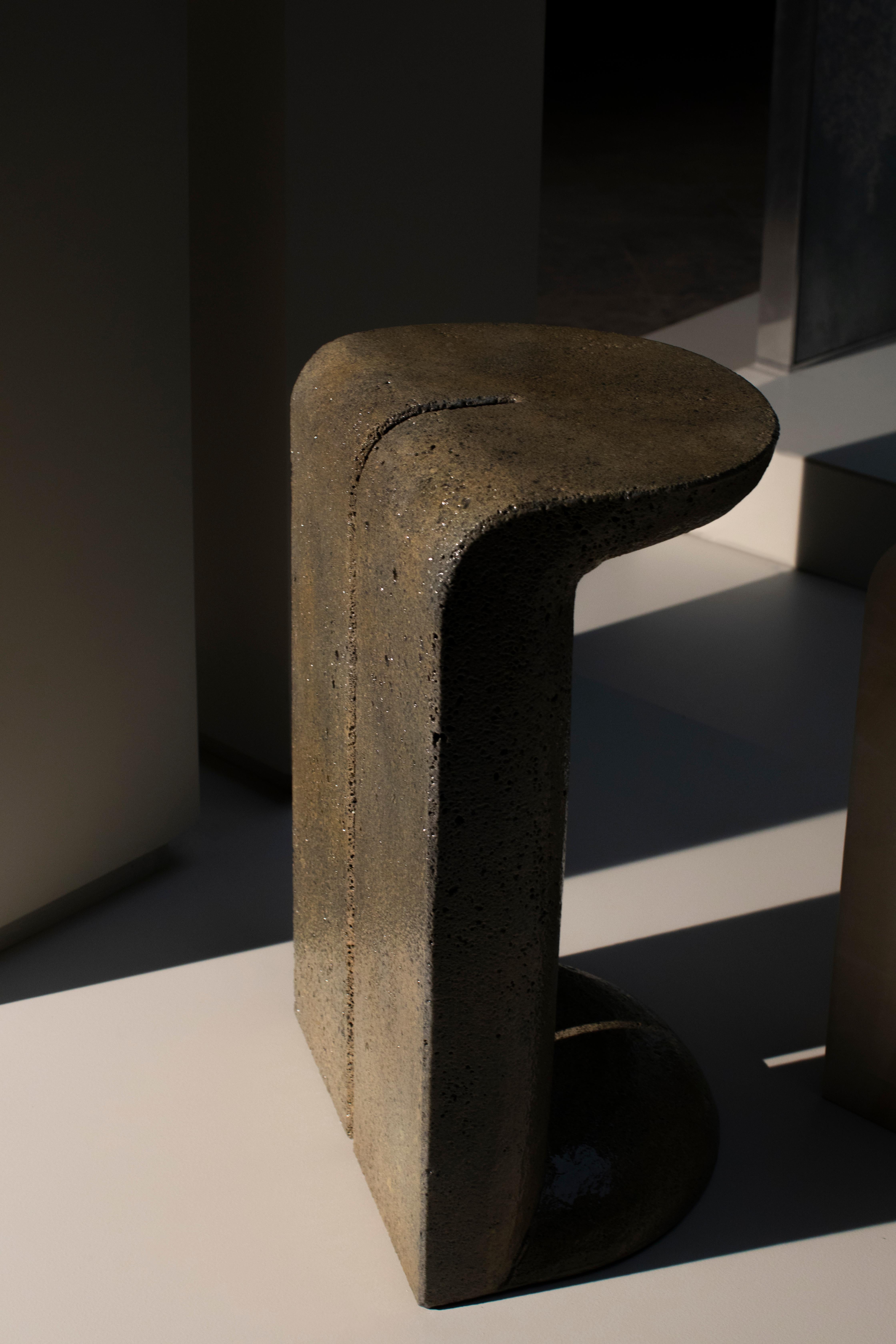 Mullunu Lava side table (2020) by Ian Felton
Lava stone, hand carved side table
40 x 33 x 66H Standard size
15.5W x 13D x 26H Standard size
Limited Edition
Edition of 15

Mullunu side table is the embodiment of those precious and unrecalled objects
