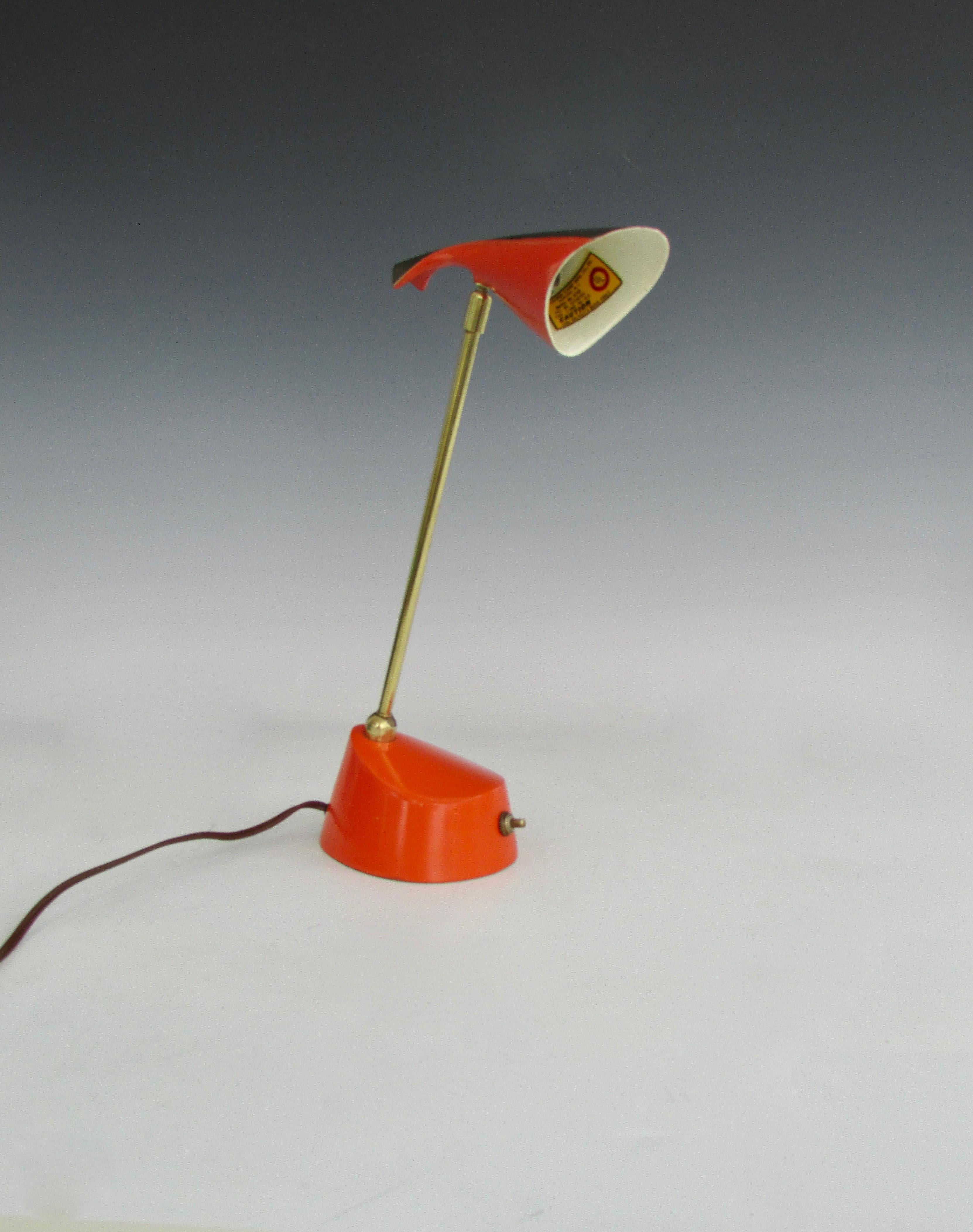 Laurel lamp co. NJ desk or task lamp in original bright orange red finish with gold trim. weighted base supports multi adjustable brass shaft supporting space age cone shade .Loop hook on underside to enable wall hanging. Retains excellent original