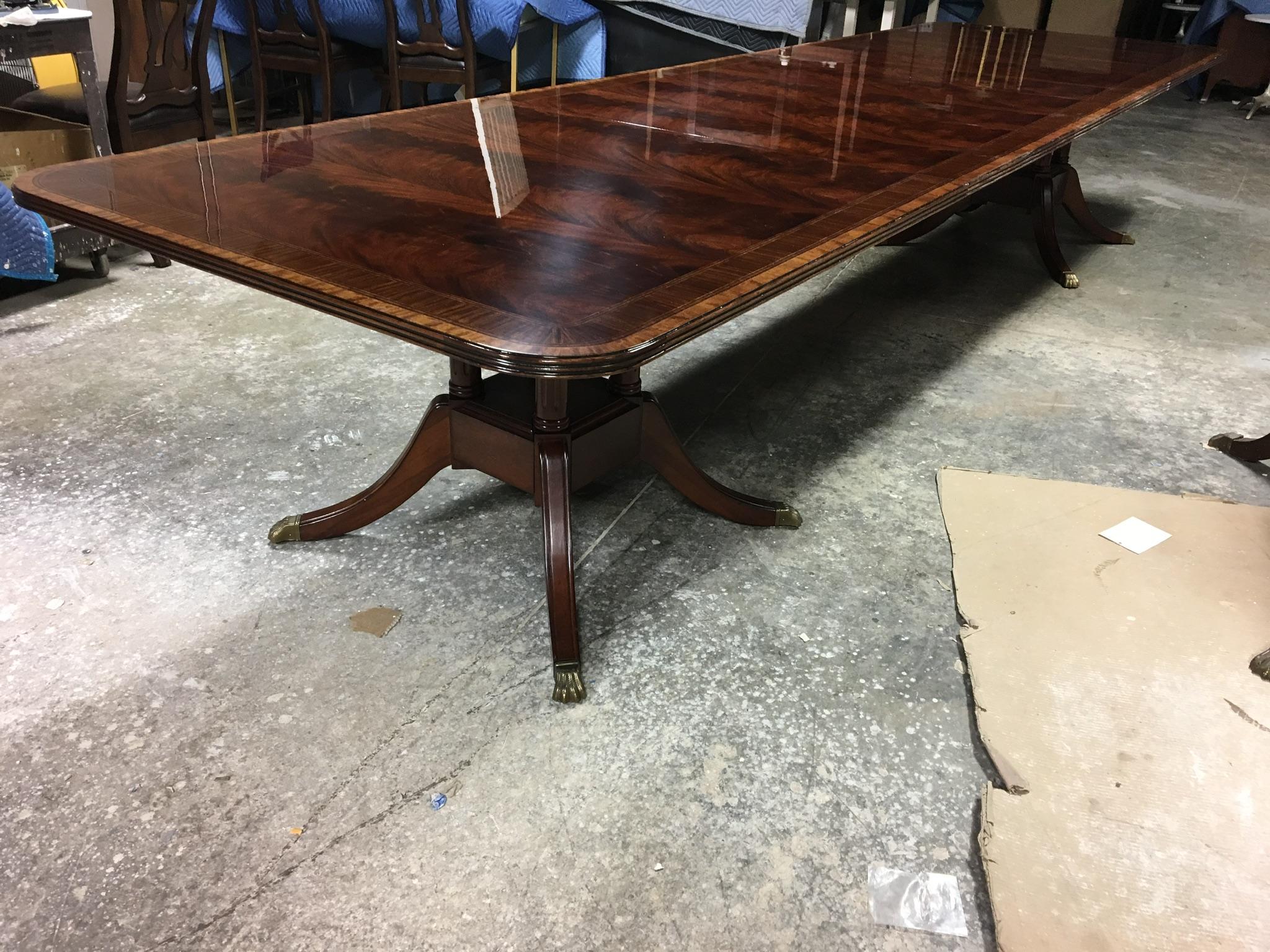 This is a made-to-order Large Traditional mahogany banquet/dining table made in the Leighton Hall shop. It features a field of slip-matched swirly crotch mahogany from west Africa and Satinwood and Pau Ferro borders from South America. It has a hand
