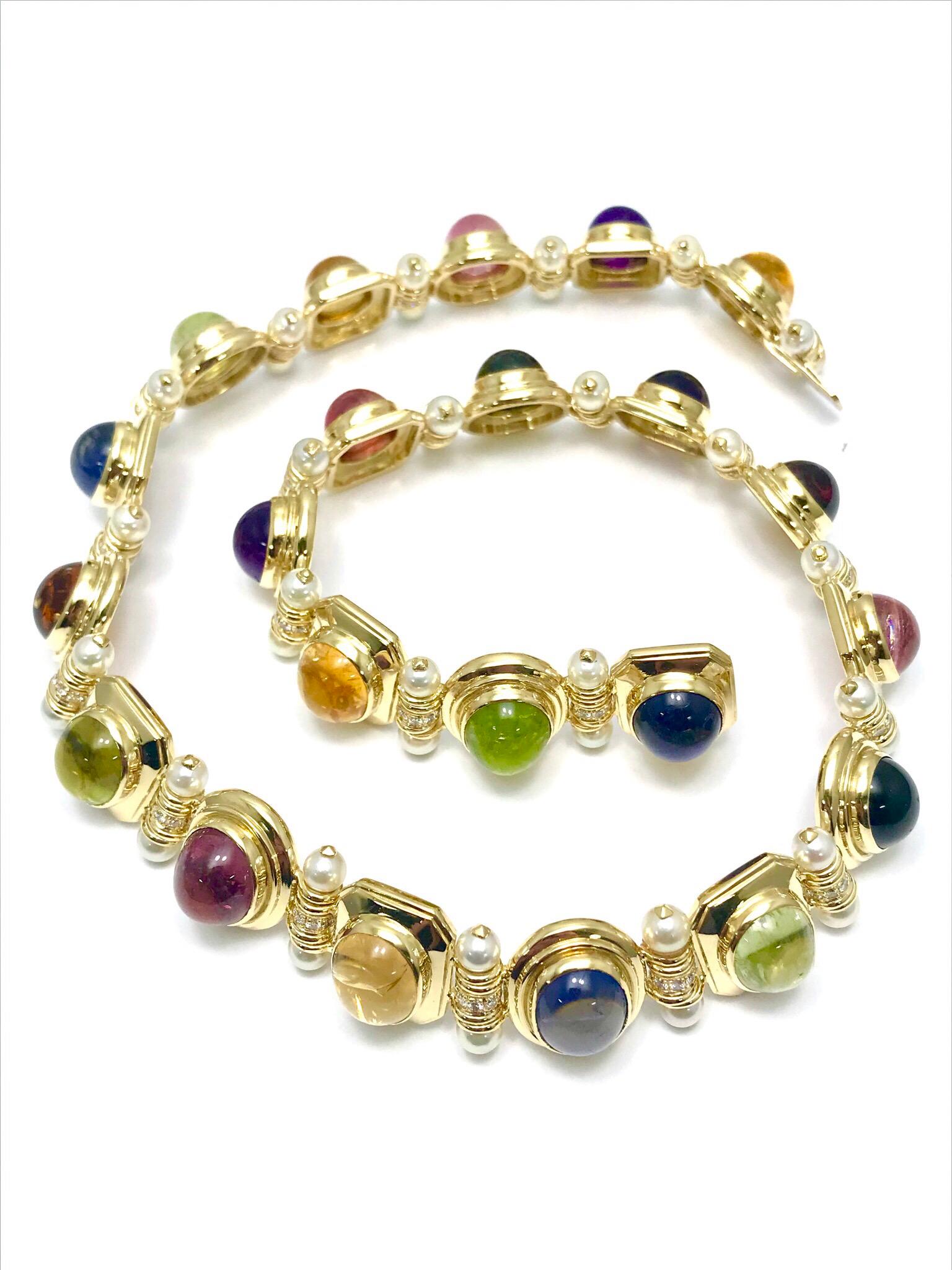 This is an exquisite Multi Gemstone Pearl and Diamond 18 karat yellow gold collar necklace.  The cabochon gemstones include Amethyst, Pink Tourmaline, Citrine, Garnet, Iolite, Amber, and Peridot, all of which are bezel set and linked together by a