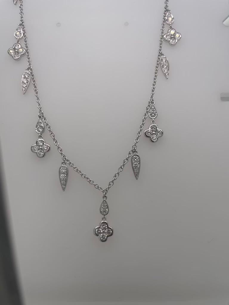 Chic white gold necklace with Louis X like charms.  This classic and wearable piece consists of 10 unique charms adorned with white diamonds.  This necklace is comprised of 18K white gold and 1.51 carats of diamonds. 