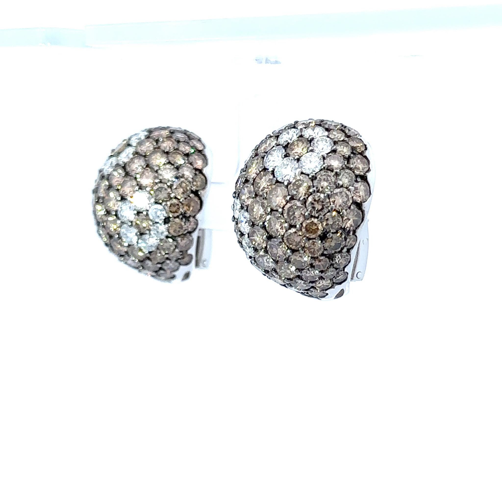 The 18k Italian white gold dome earrings with 28 carat brown and white diamonds are a truly exquisite and opulent piece of jewelry. Crafted with precision and artistry, these earrings showcase the perfect fusion of luxurious materials and