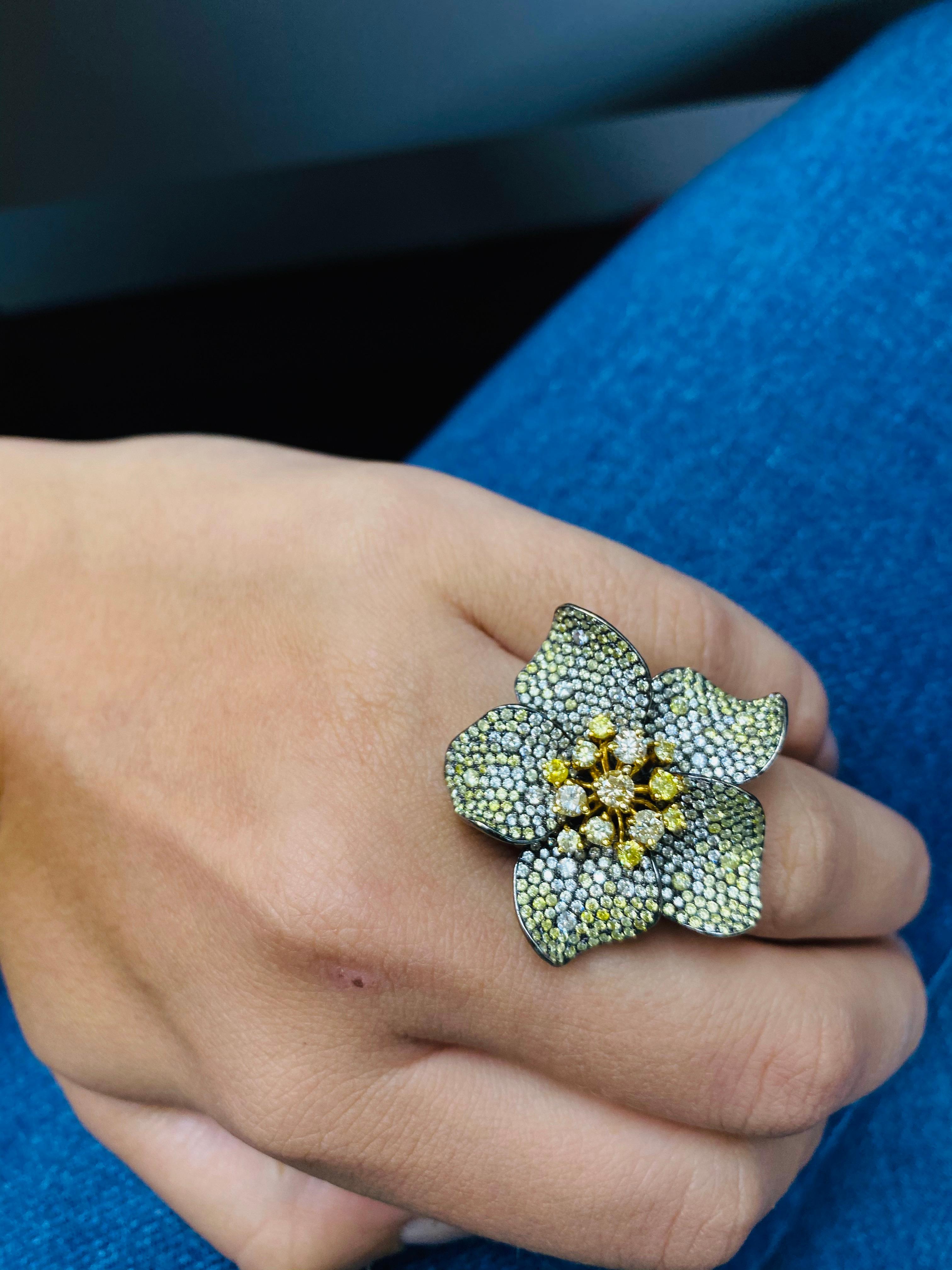This beautiful flower diamond ring, made of 18KT white gold and some touch of yellow gold, features 7.00 Carats of different color and different shape diamonds. 

All near colorless white, slightly included.