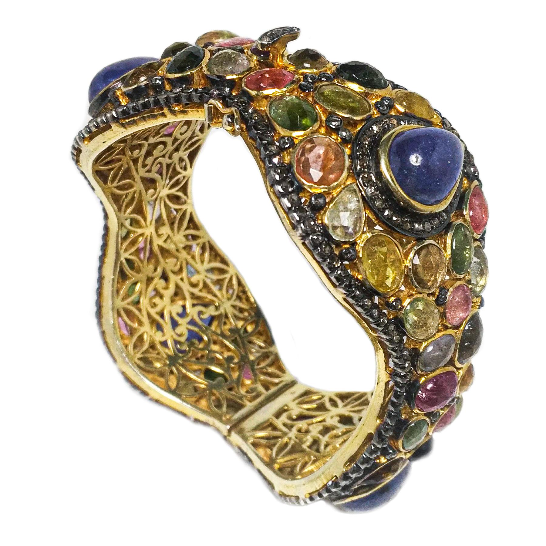 Moghul inspired, multi color gemstones bangle. Handcrafted fancy design contain natural violet blue pear shape tanzanite, with multi color tourmalines, set in yellow gold bezel setting, accented with oxidized frame with micro pave diamonds.