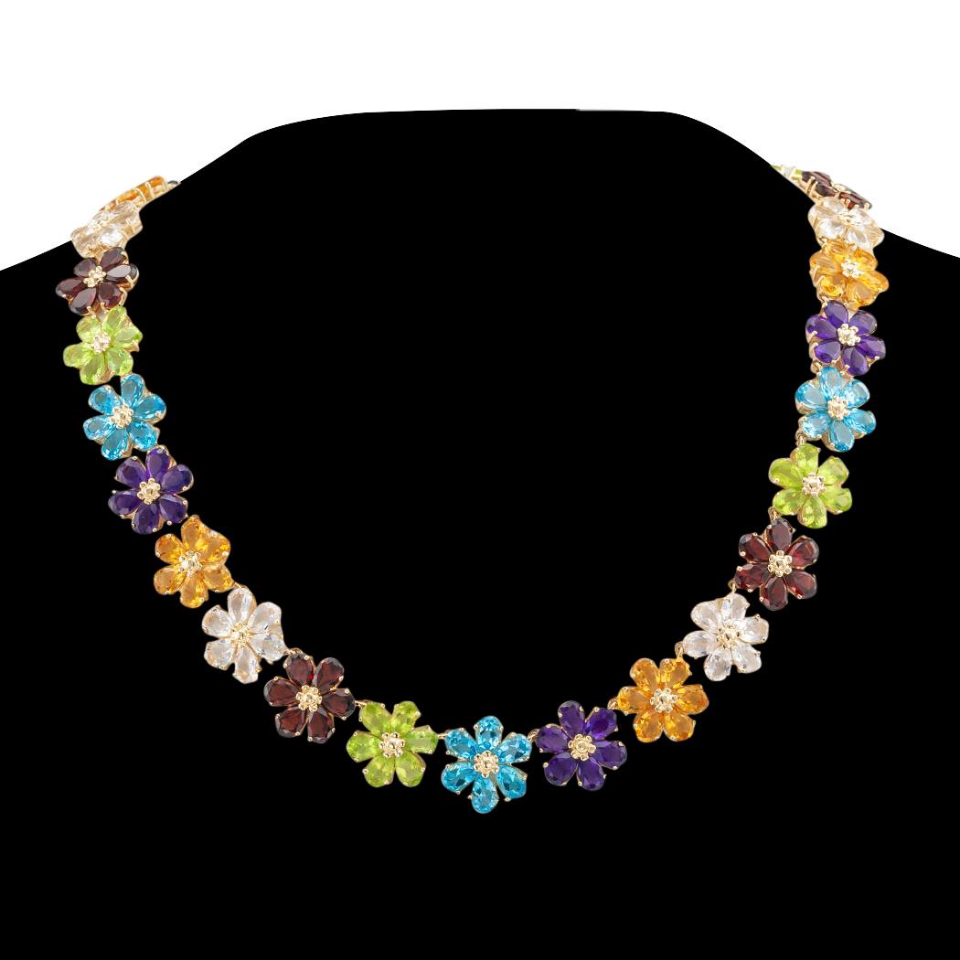 Multi color gemstone flower link and gold necklace circa 1990.

DETAILS:

GEMSTONES:  set as individual flower head-shaped links comprising pear shaped amethyst, blue topaz, citrine, garnet, peridot, and quartz.

METAL:  14-karat yellow