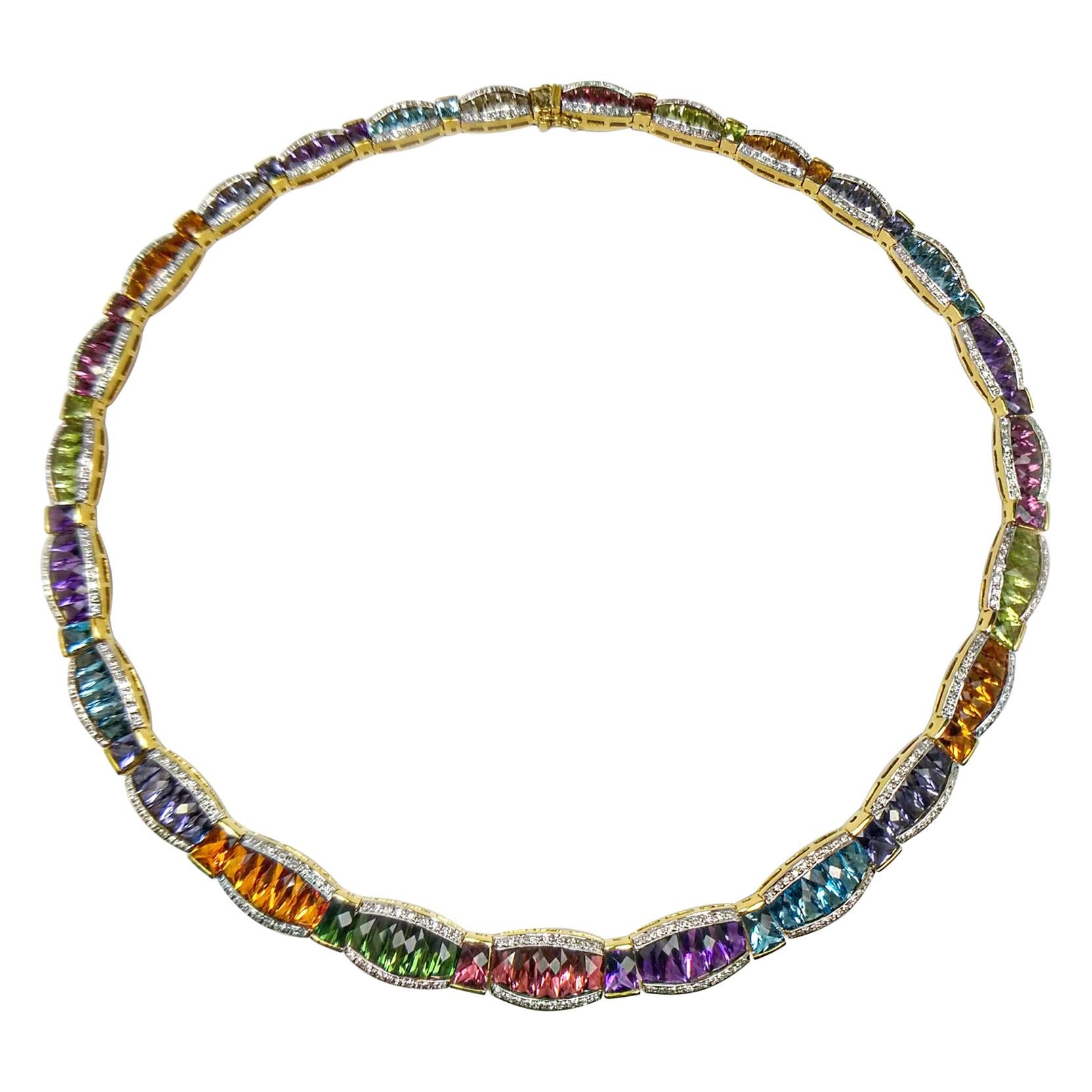 Striking multi color gemstone and diamond necklace. Beautiful graduated barrel design necklace with lively, colorful gemstones in rectangular, tabular and lozenge faceted, encased in tension mount and yellow gold bezel set. Contemporary handcrafted