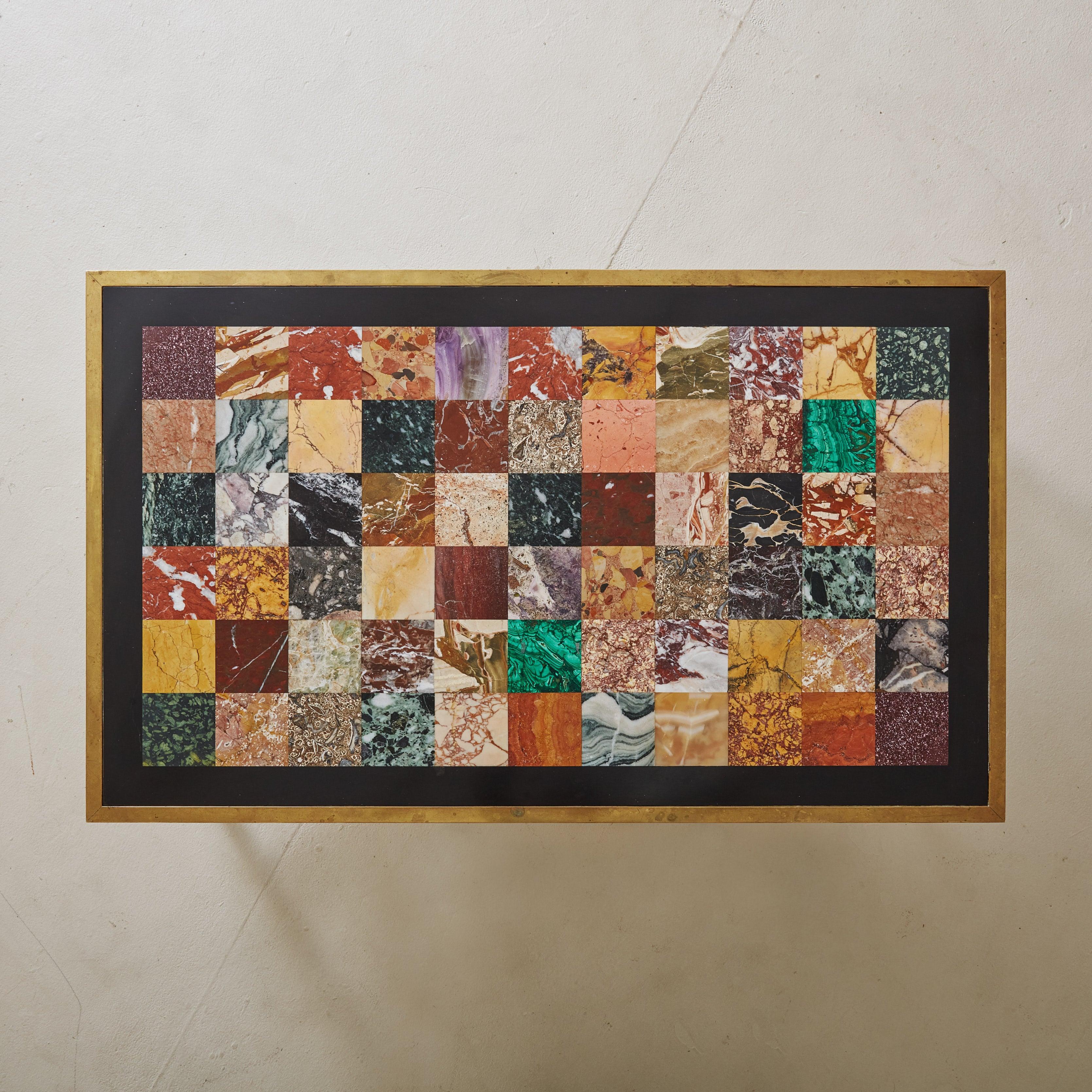 A 1960s rectangular coffee table featuring a gorgeous multi-colored marble inlaid top. Each square tile has a unique and vibrant hue, creating an eye-catching mosaic-like pattern. The rich jewel tones and fluid veining provide a striking contrast