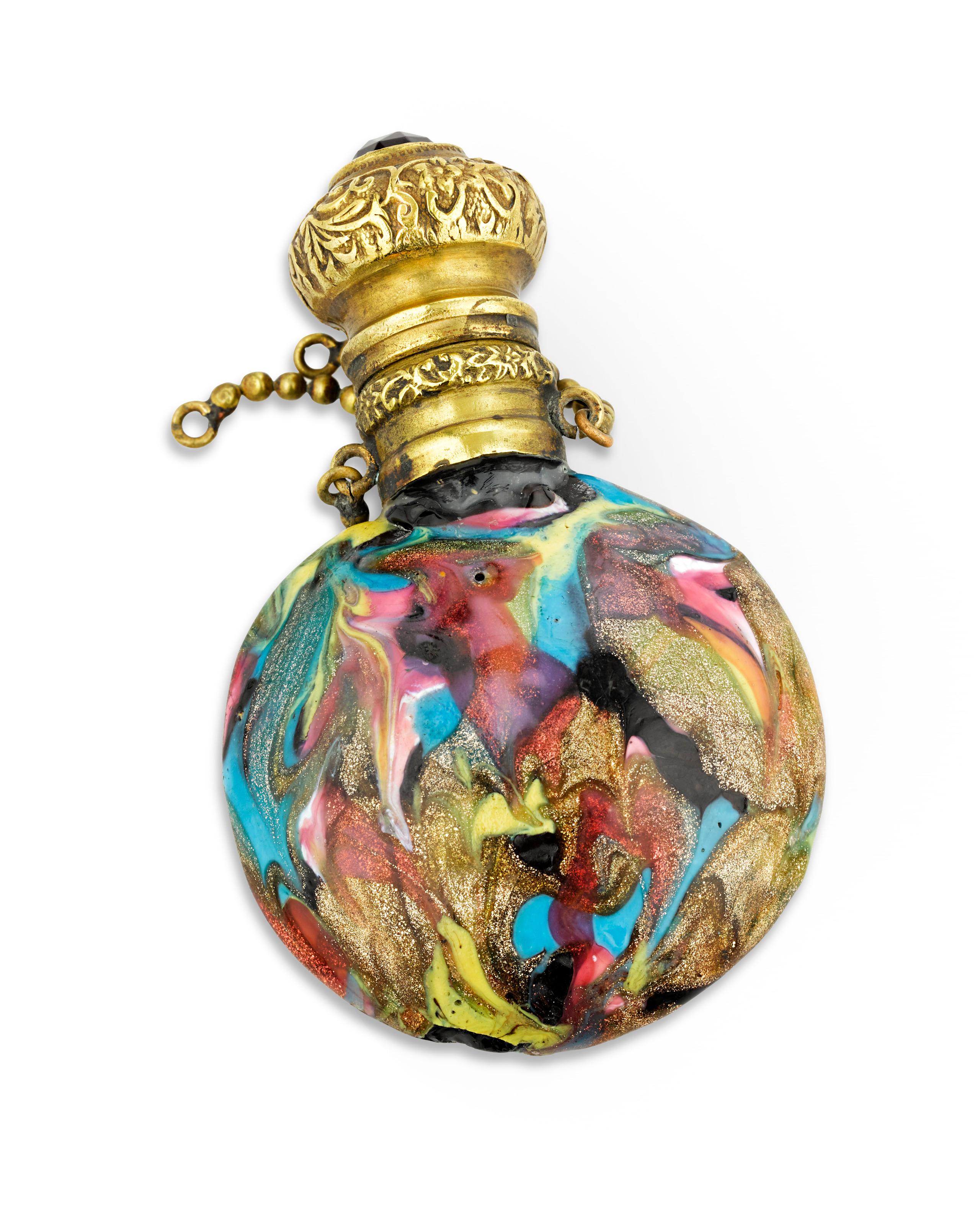 Vibrant yellows, pinks, golds and blues decorate this lovely Venetian marbled glass scent bottle. A chased gilt stopper completes the perfume.

Late 19th century

1 3/4